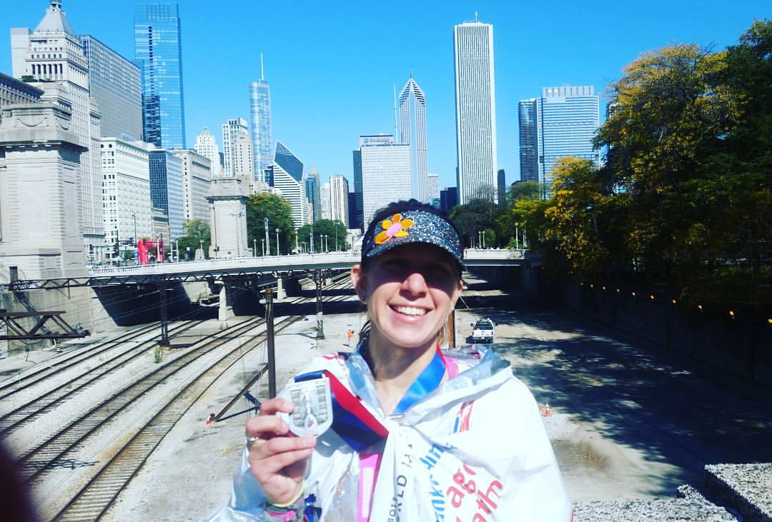 Finish and medal picture with the city behind.