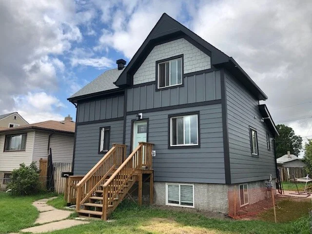 Siding: James Hardie Plank & Panel in Night Grey, Shingle in Light Mist Trim: James Hardie Midnight Black