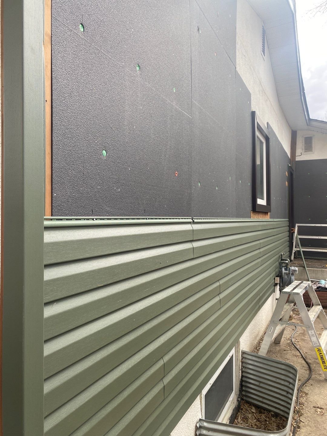 vinyl siding and insulation over stucco.jpg