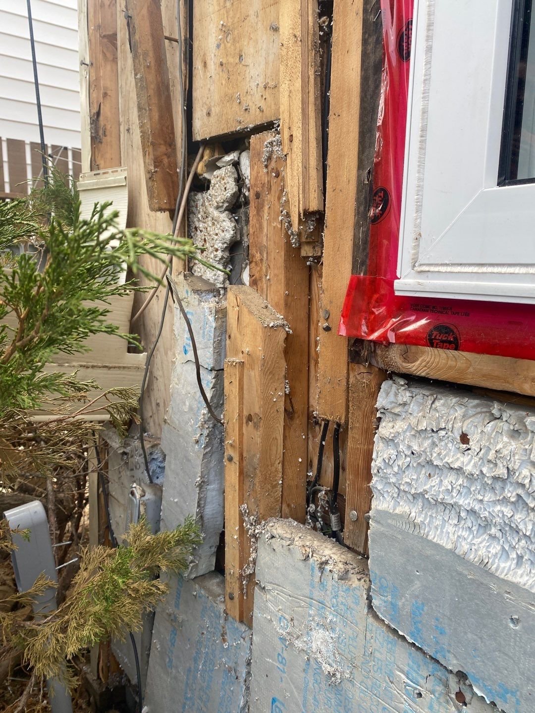 A mess of strapping, framing, insulation, stucco, and drywall.jpg