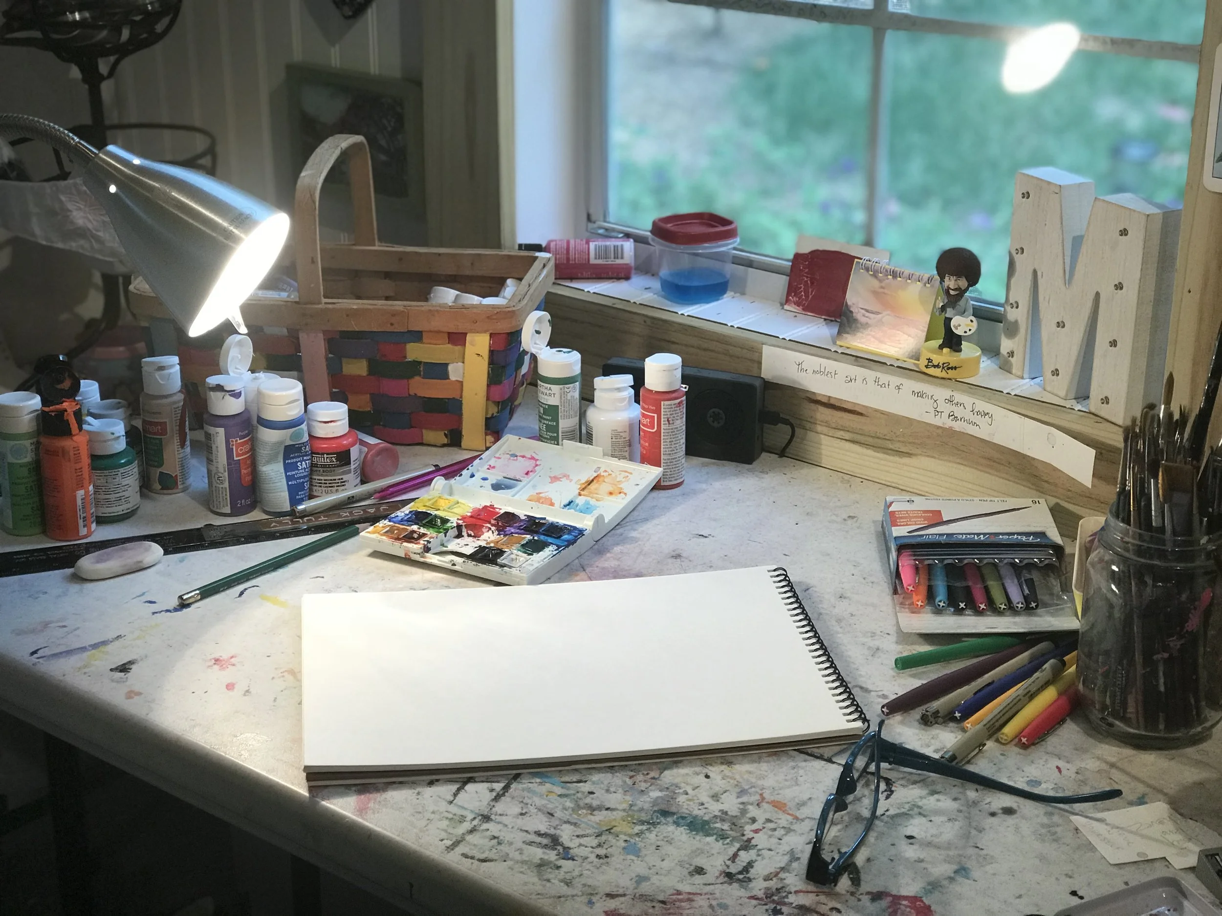my desk. this is pretty much what it looks like all of the time. in the mornings, a coffee cup sits just under my light.