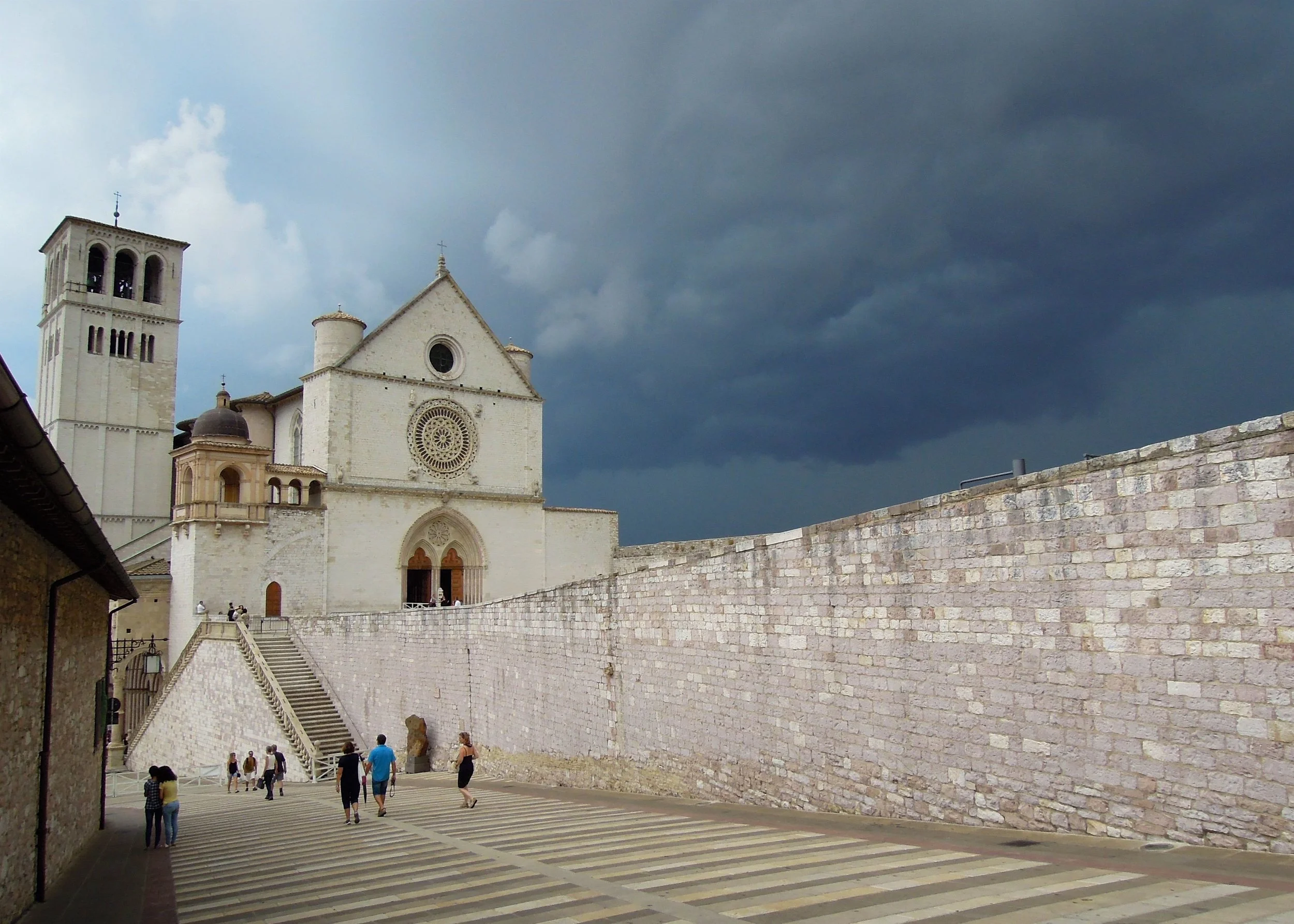 The skies about to break loose above Basilica of Saint Francis of Assisi. I highly recommend you also see the inside. Photograph: Alison Testroete
