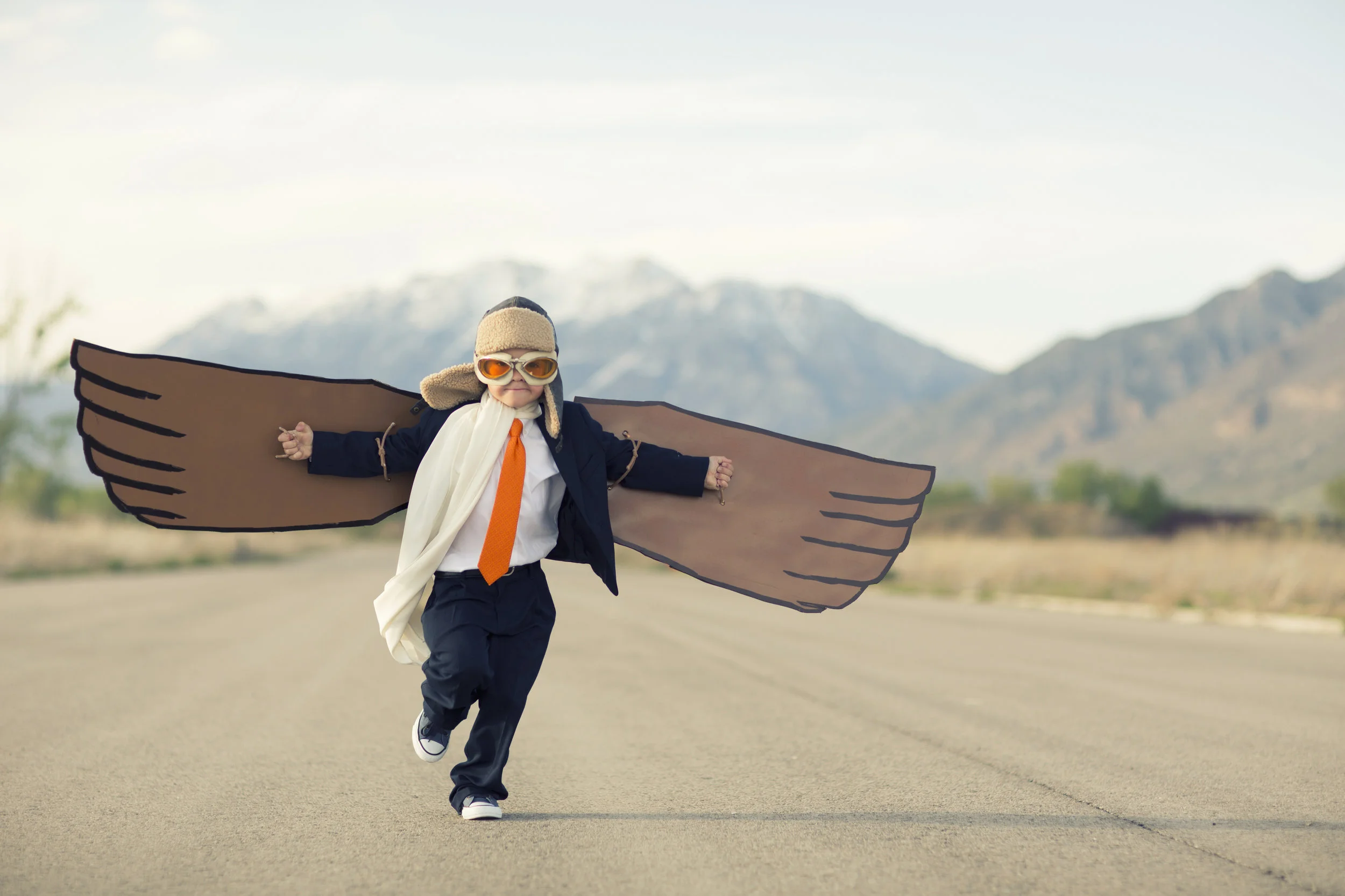 Young-Boy-Businessman-Dressed-in-Suit-with-Cardboard-Wings-623590688_3869x2579.jpeg