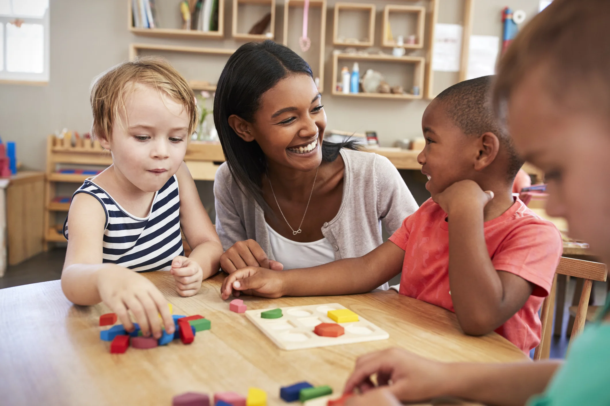 Teacher-And-Pupils-Using-Wooden-Shapes-In-Montessori-School-684059604_2125x1416.jpeg