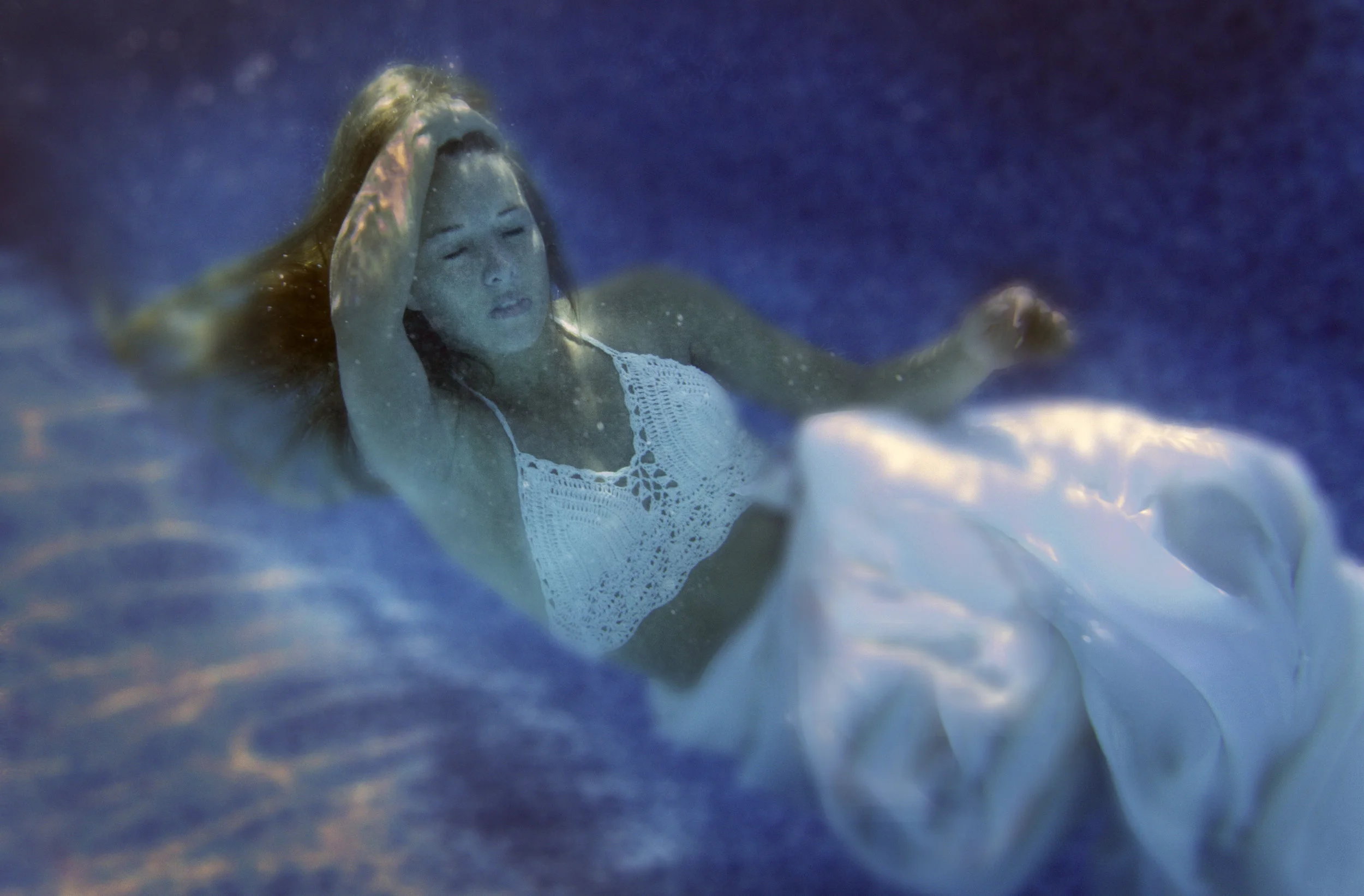 The focus of underwater series is the fluidity of the feminine energy immersed in water; the beauty of the ethereal form with movement and flow. Roche's work is a blend of realistic and impressionist style. Initially the art begins with underwater photography. There your options are photographic c prints, fine art prints and our artist renderings. The rending image is prepared with blending, dodging and burning light prior printing. Hand printing on archival premium weight canvas with a broad, deep weave. Roche paints with acrylic & oil, gold, silver metallic leafs and translucent inks. Then embeds semi-precious materials (with healing properties), metal pigments, minerals and crushed glass into several layers of resin epoxy finish that encases the works depths and adds a distinct beauty. The process is to create artwork the is both healing and beautiful.