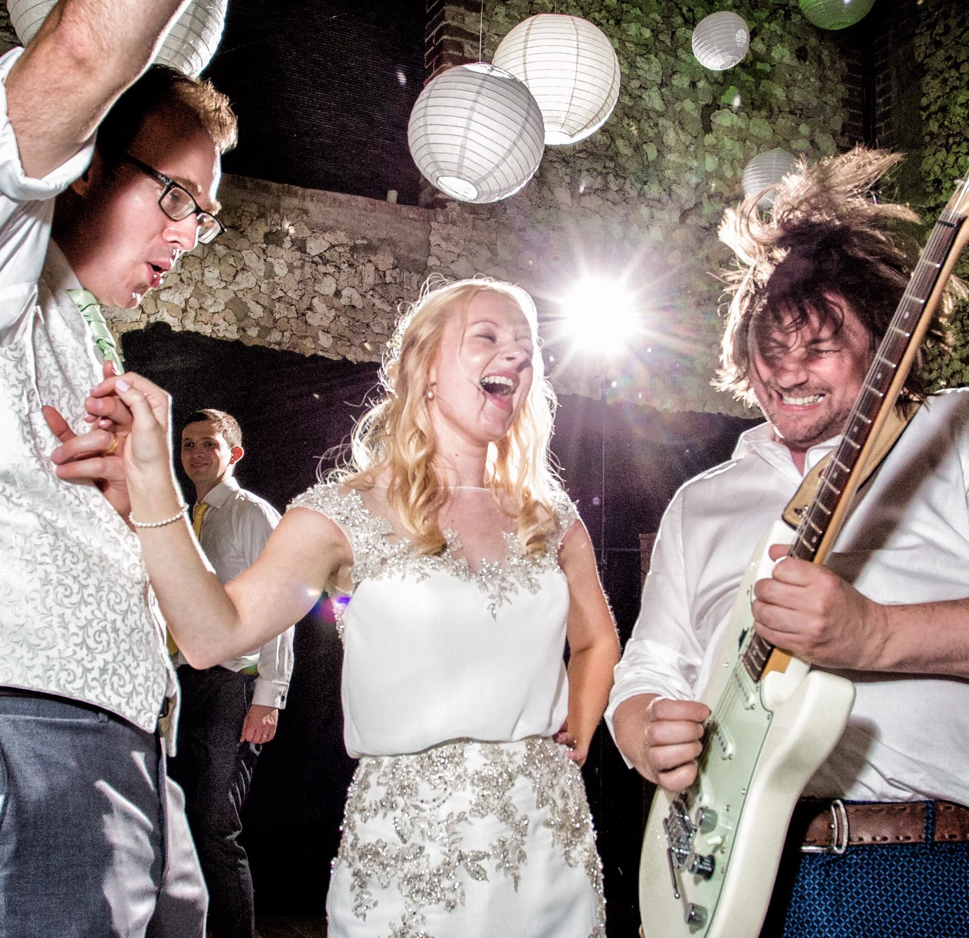Michael going crazy with his guitar and the bride and groom ecstatic.