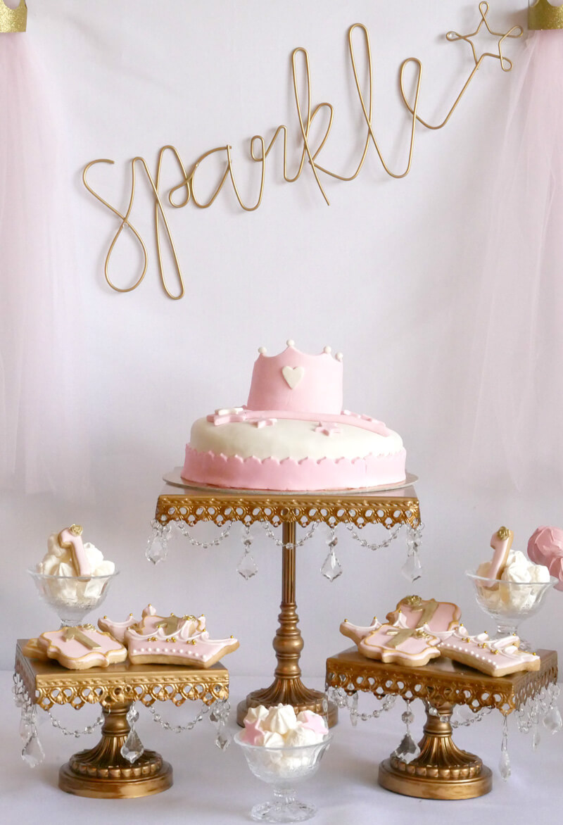 Adorable Princess party idea in pink and gold, dessert table with gold cakes stands
