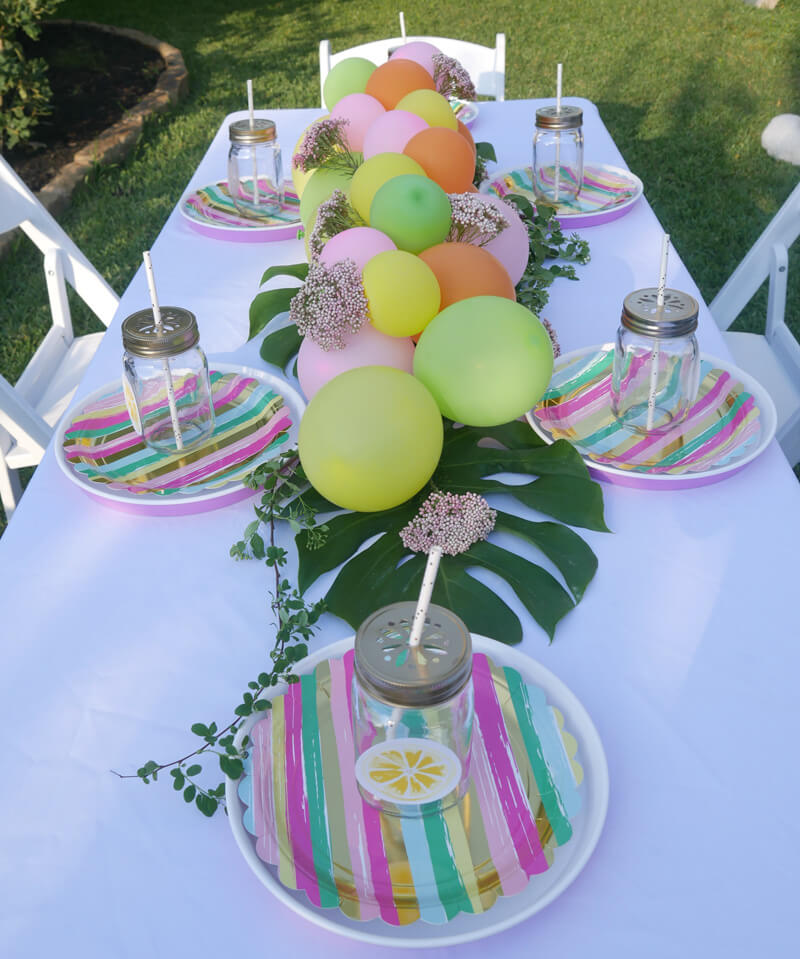 Tutti Frutti Party / Tropical themed birthday party with stripes and balloons / balloon garland centerpiece / created by Carolina of Mint Event Design in Austin Texas www.minteventdesign.com