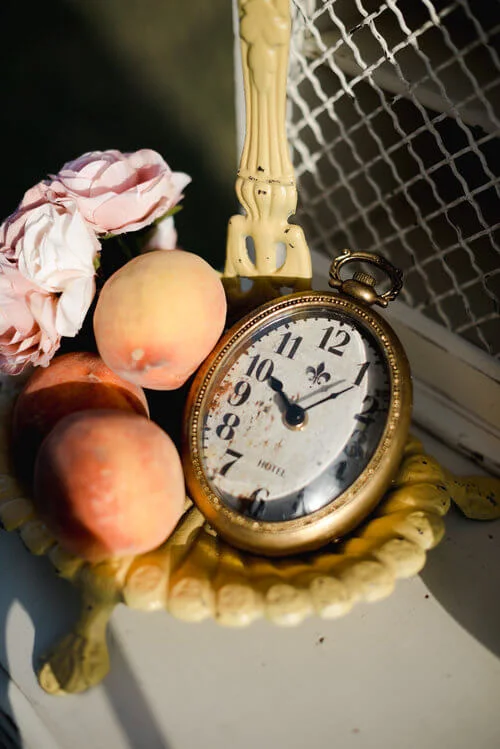 French antique decor with fresh peaches on an antique desk.