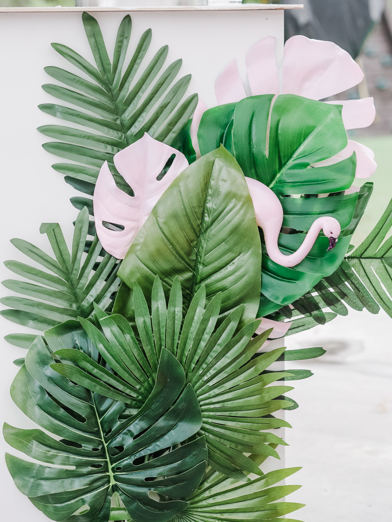  Layered oversized palm leaves with a flamingo tucked in created a super easy and fun tropical party decoration. Come see all the tropical party details on Mint Event Design www.minteventdesign.com 