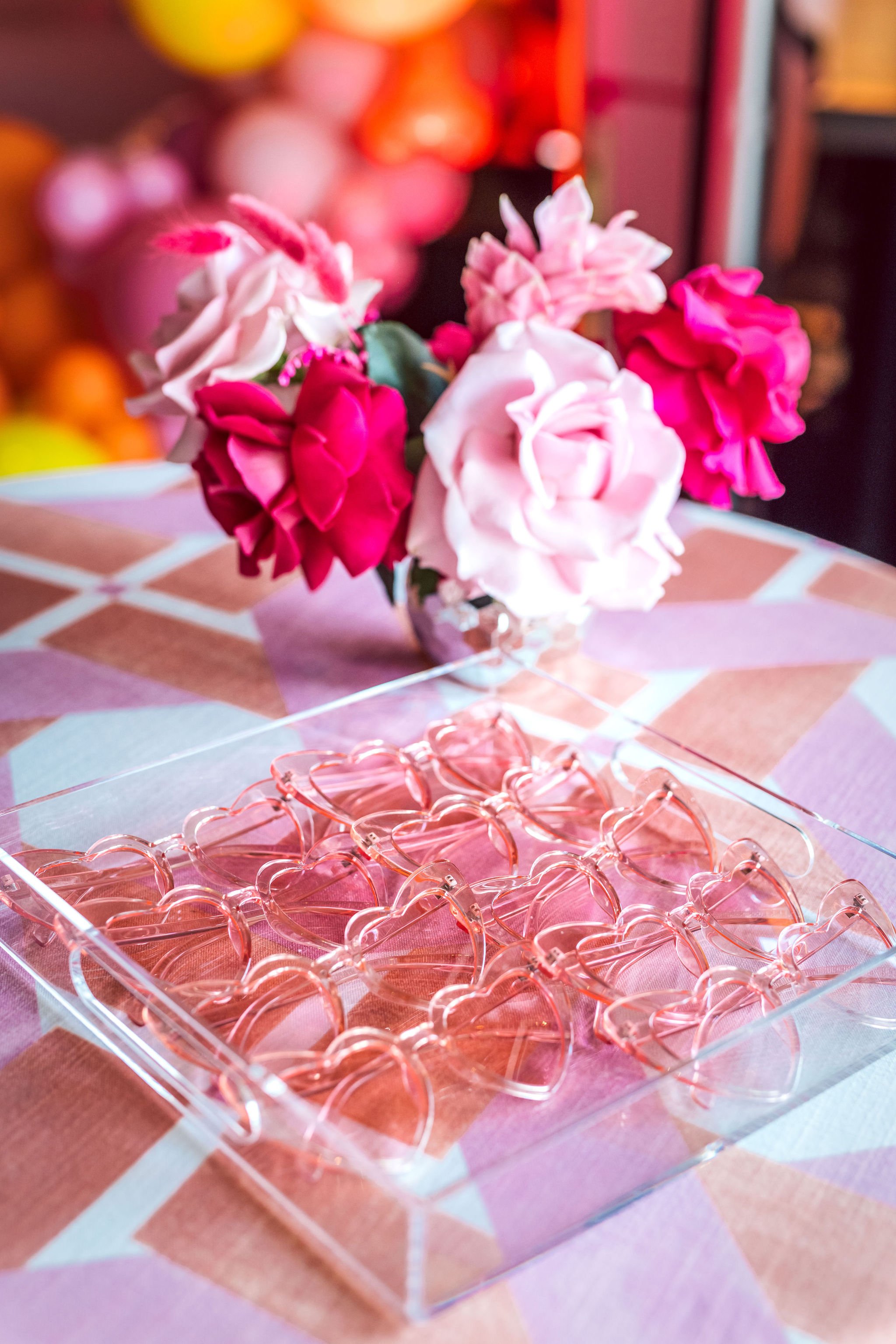 Barbie Party florals and pink heart sunglasses. Get more ideas for a Barbie Movie Party at www.minteventdesign.com!