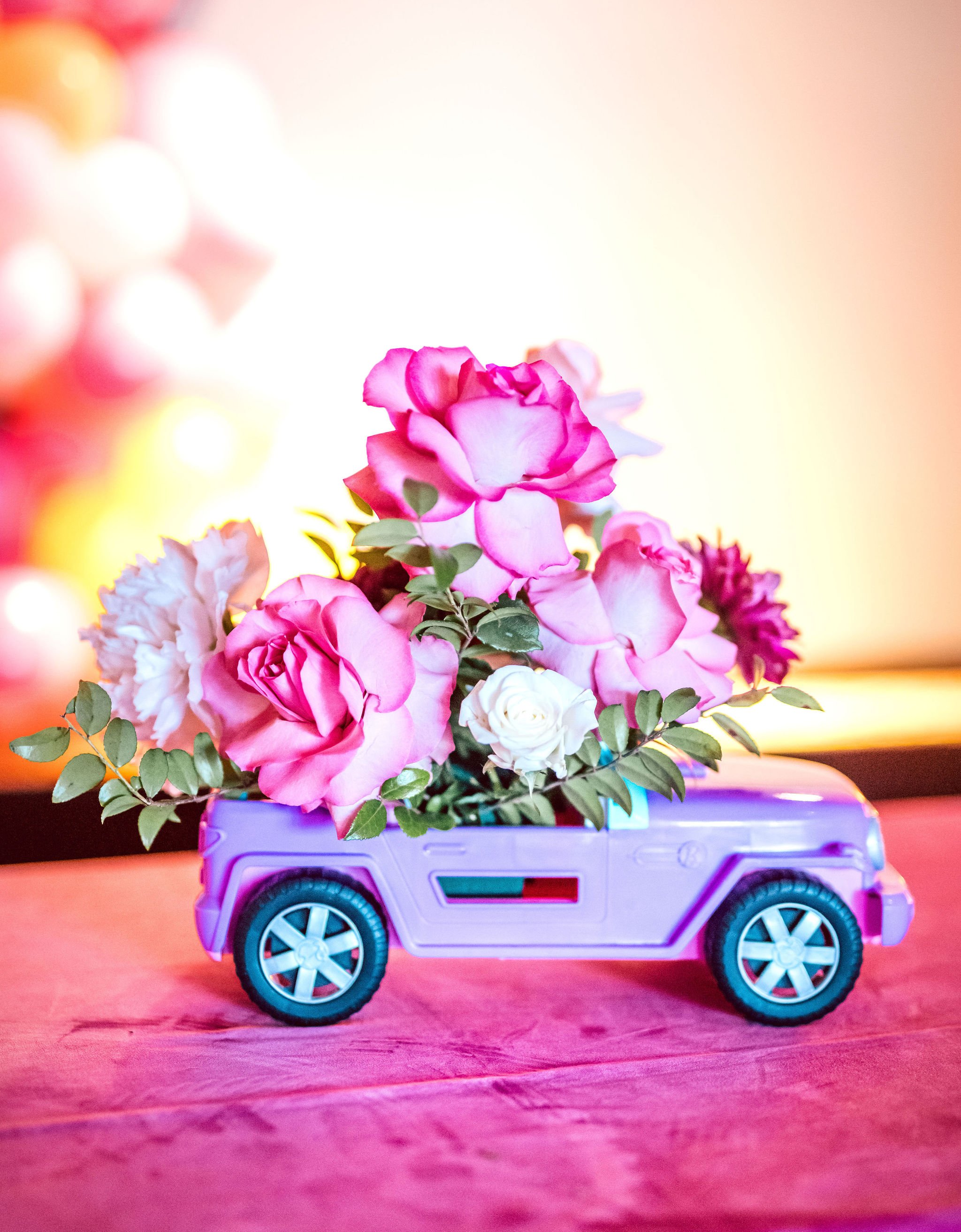 Barbie Jeep pink floral Centerpieces. Get more ideas for a Barbie Movie Party at www.minteventdesign.com!