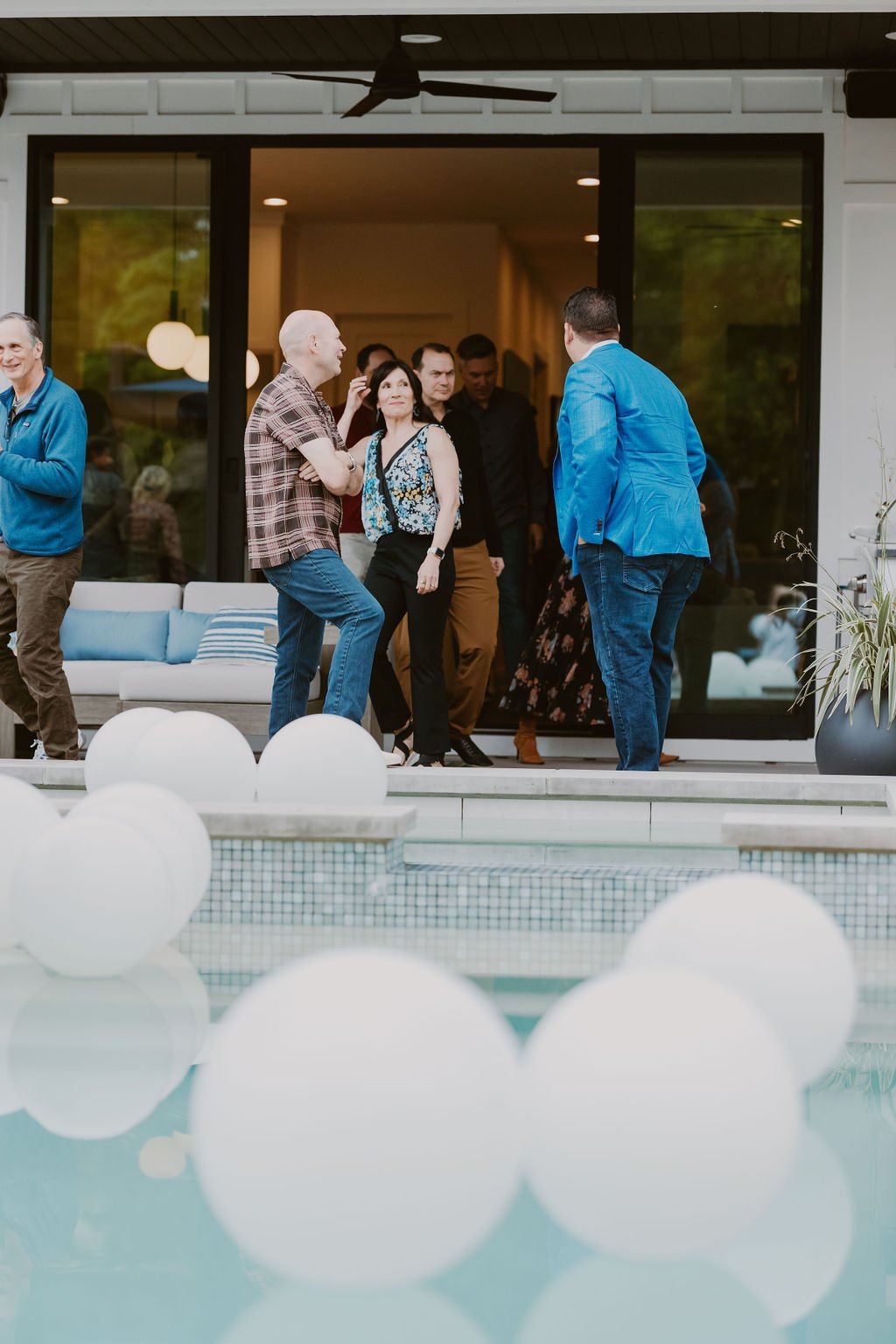 Pool balloons at an elegant backyard 50th Birthday Surprise Party. Get more ideas from event designer Carolina of MINT Event Design in Austin, TX at www.minteventdesign.com!