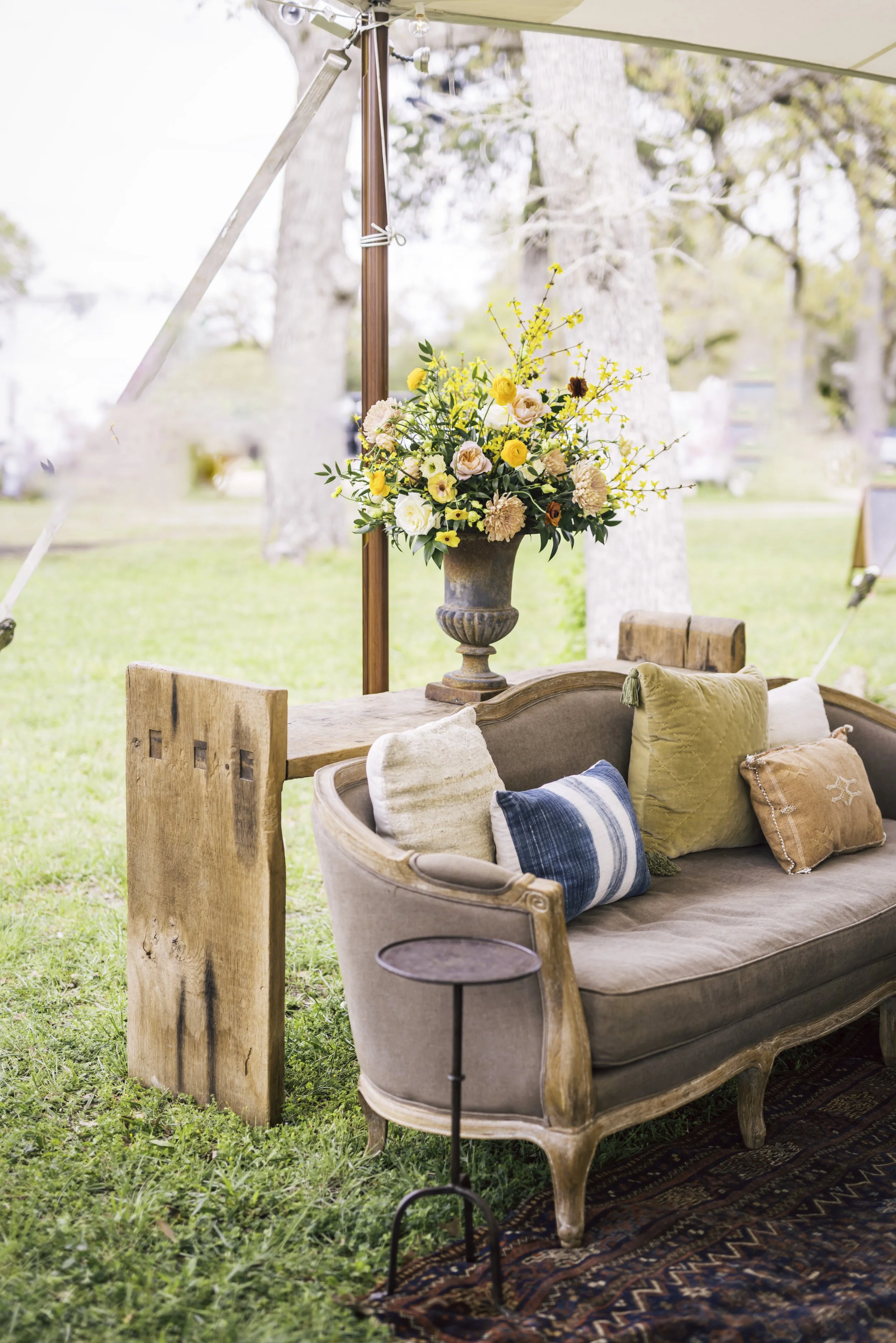 Outdoor lounge seating and floral arrangement designed by Austin event planner Mint Events
