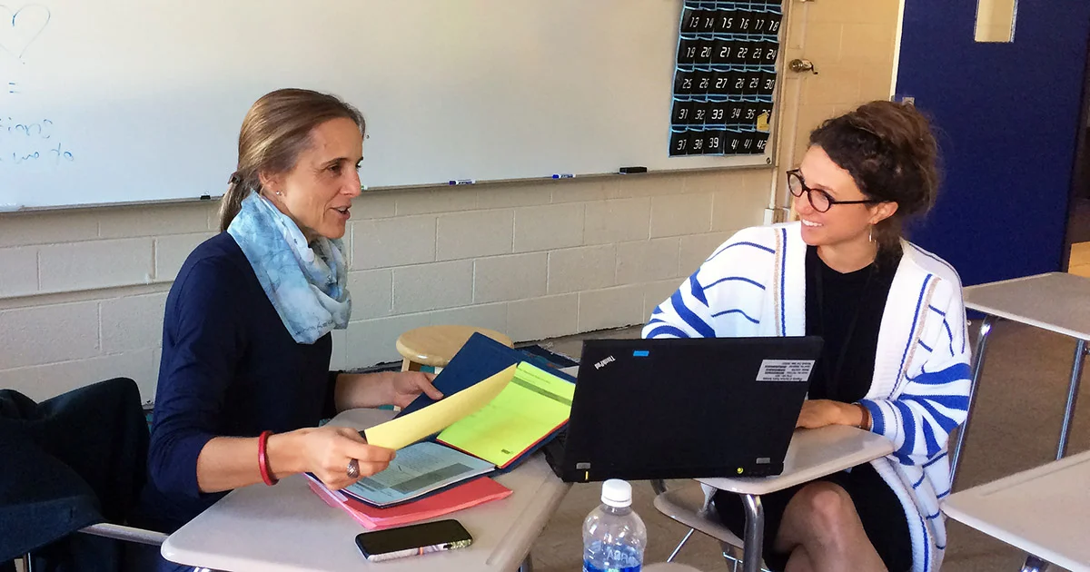 Daria Witt reviewing resources from previous day’s workshop to support English teacher Happi Adams from Jordan High School in Durham, North Carolina in incorporating key strategies into her curriculum.