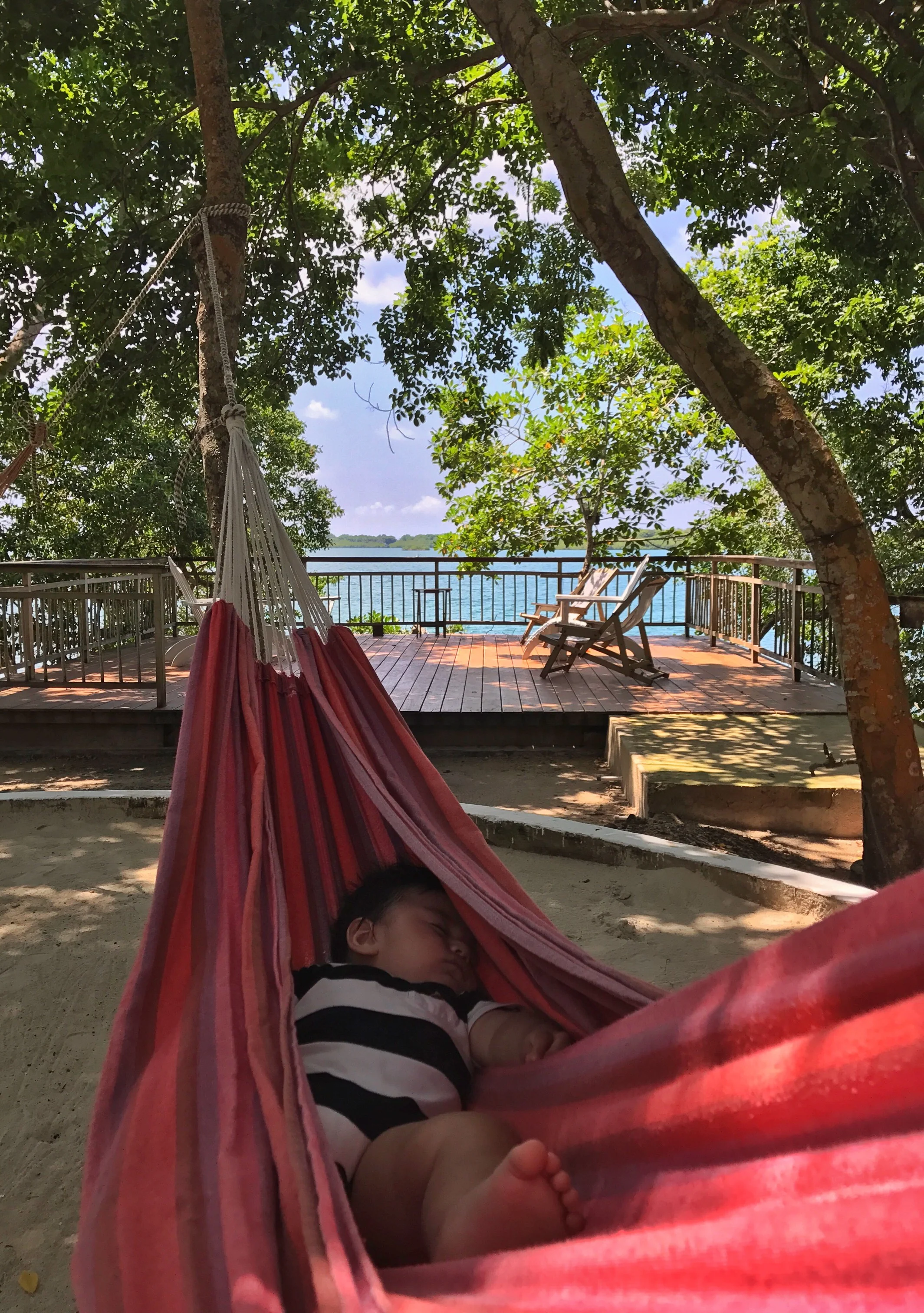  Once we arrived at our house rental, little Charlie napped in the hammock while we sat in the beach chairs enjoying the breeze and the beautiful views of the water. Our house rental did not have its own beach area but it did have a dock with a slide