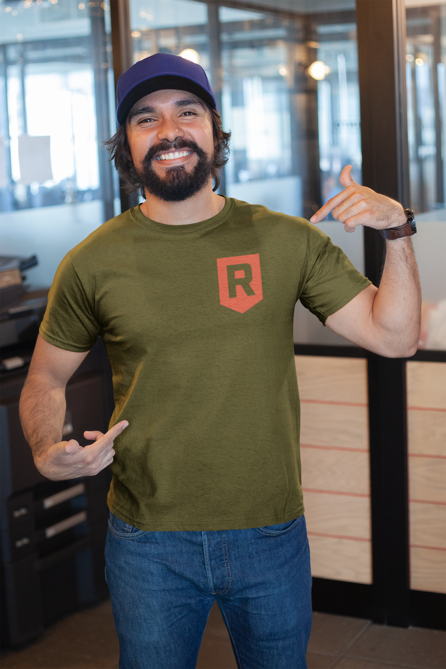 mockup-of-a-happy-customer-showing-off-his-t-shirt-inside-a-modern-office-26189.png