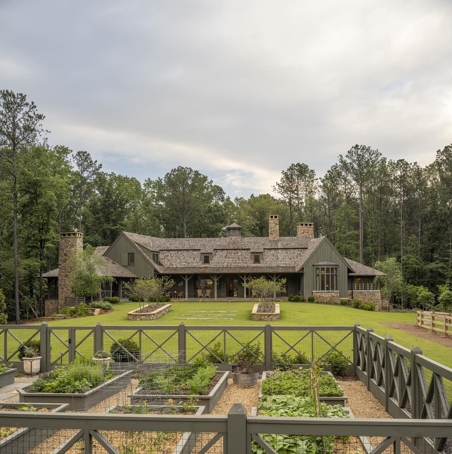 An over-the-garden view of our Shelby County farm project, through the lens of @landinophoto  Local stone, cedar roof and cypress siding feel right at home in this setting of woods and fields. 
.
.
Architect: @carlislemoorearchitects 
Interiors: @lyn