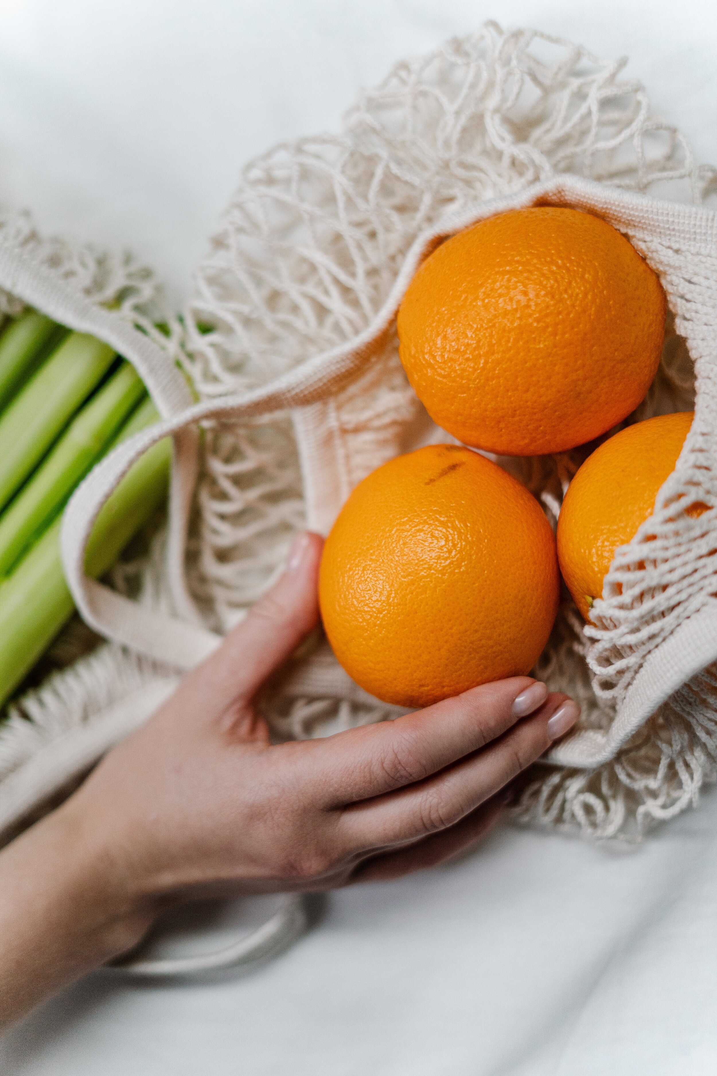 person-holding-orange-fruit-3737690.jpg