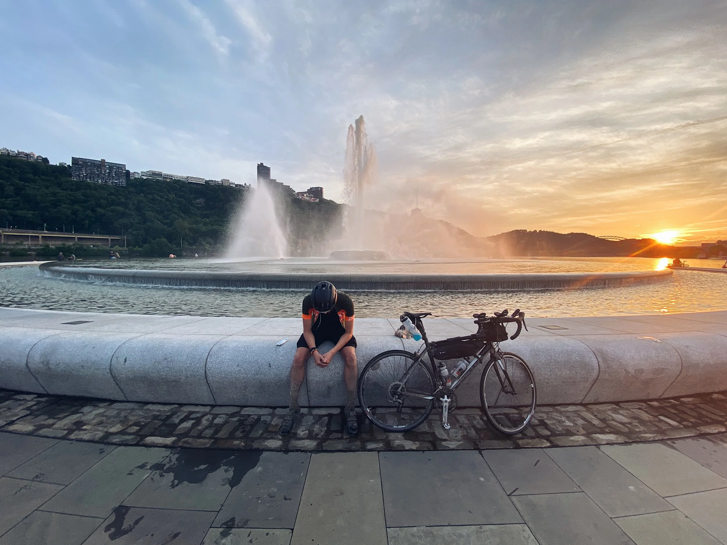 Cyclist at Point State Park Fountain in Pittsburgh at Sunset