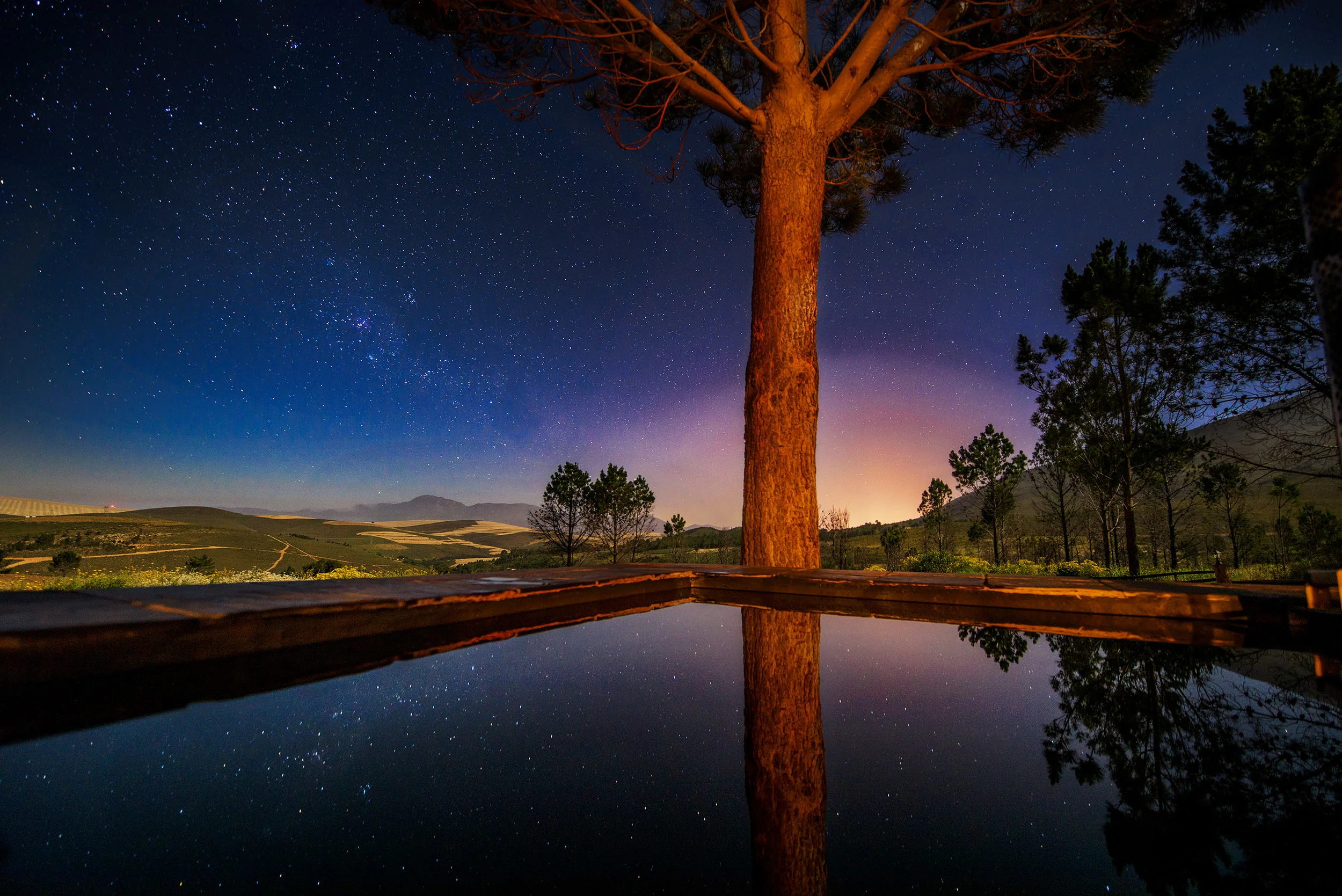 Midnight stars reflect in the wood-fired hot tub at Kolkol Mountain Lodge.