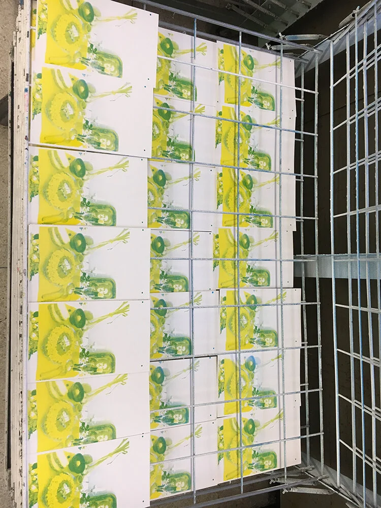 The first two layers (Yellow and Cyan) were looking great! I was printing 100 copies, and ended up with about 18 finished books. A few mistakes are already visible in this photograph. I did, however, curate out any prints that came out “too perfect”…