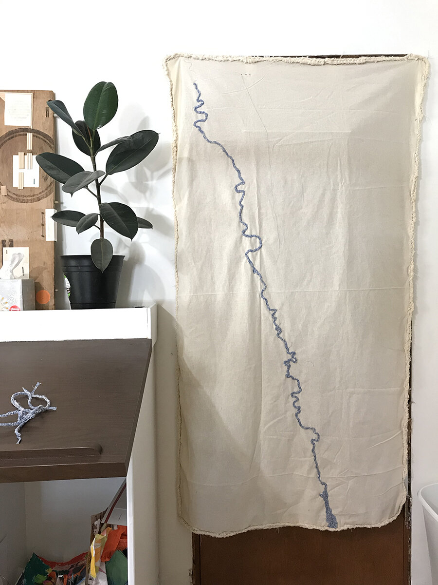 It looks great! I sewed the crochet ribbon of water onto my fabric map, with the area that runs through the town in the very center of the canvas.