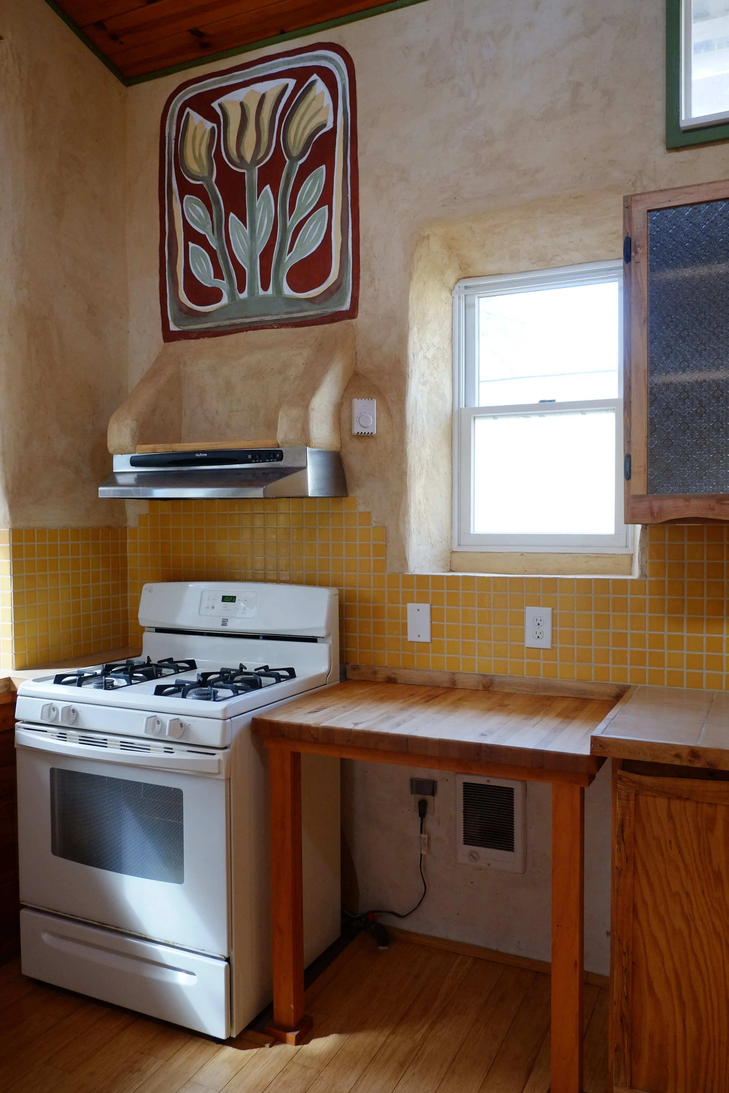 lime milk paint mural over natural plaster in kitchen