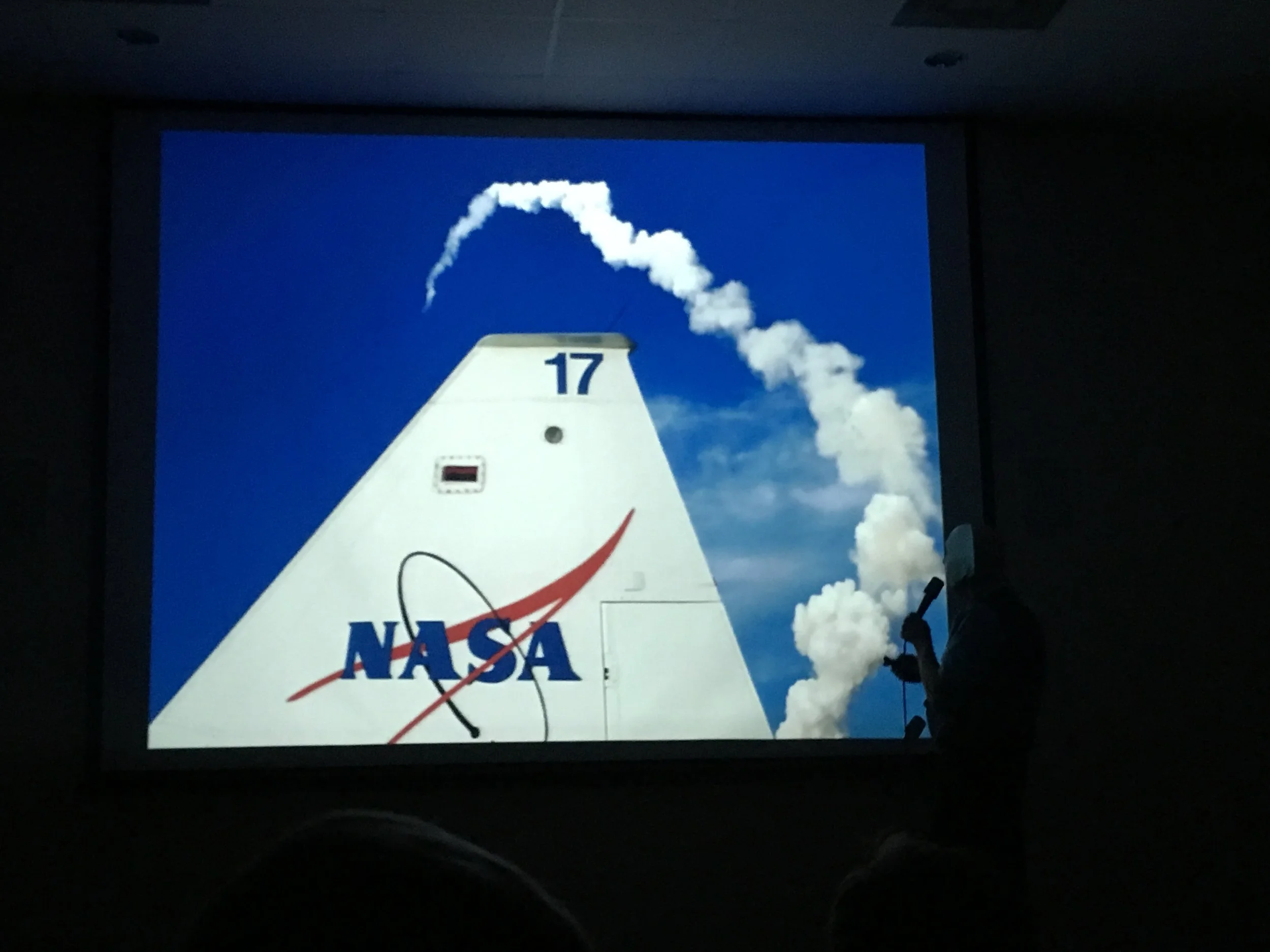 A Shuttle launch arcs over the tail of a T-38. (Slide image: Story Musgrave)