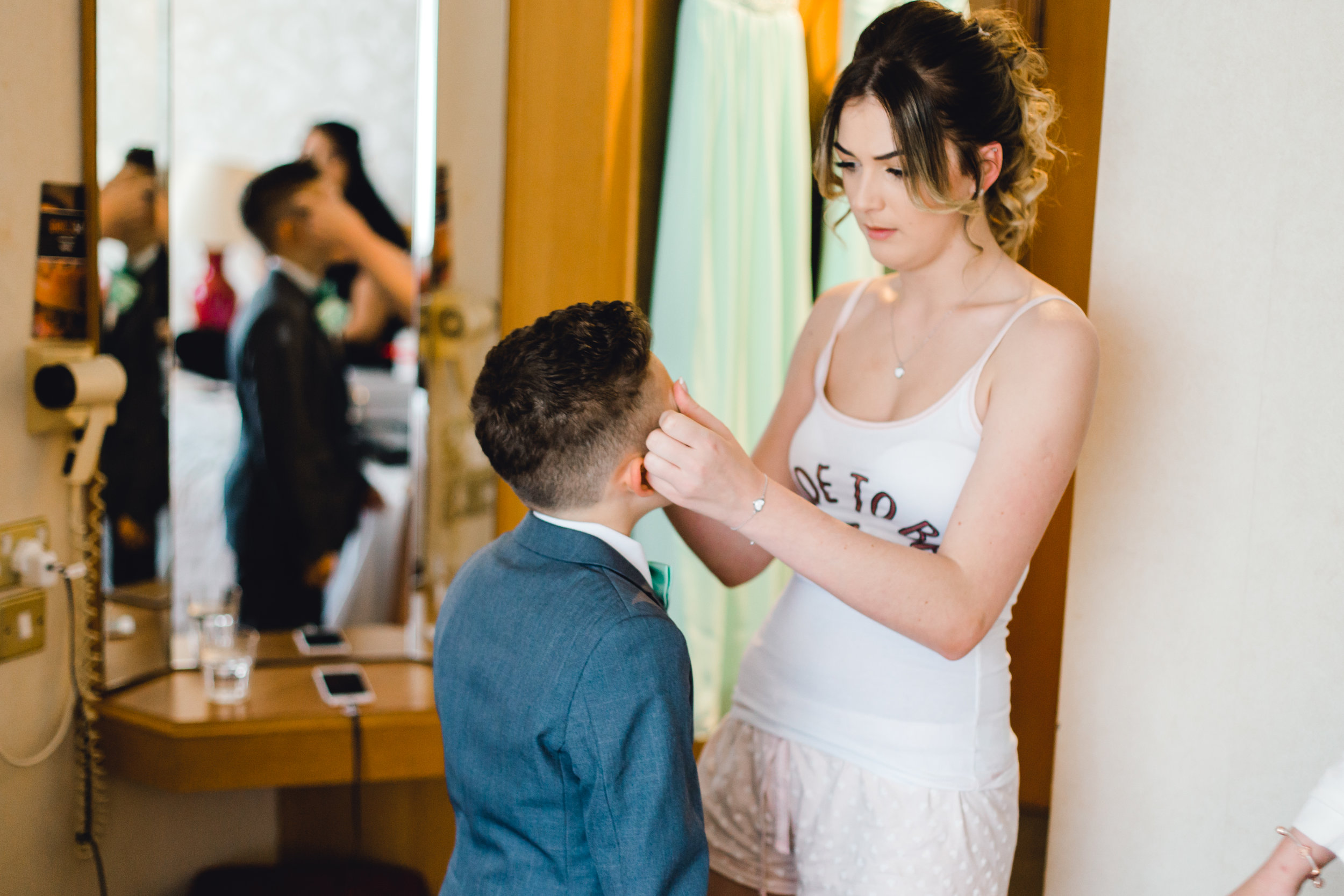 Bride and nephew share a moment during morning preparations of the wedding day