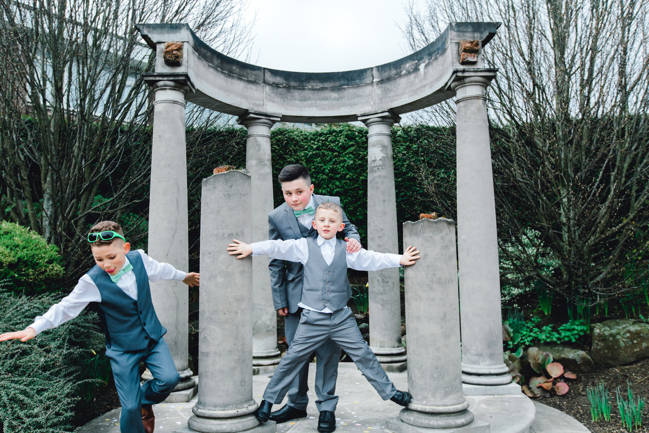 Funny kids at a wedding during the formal photos