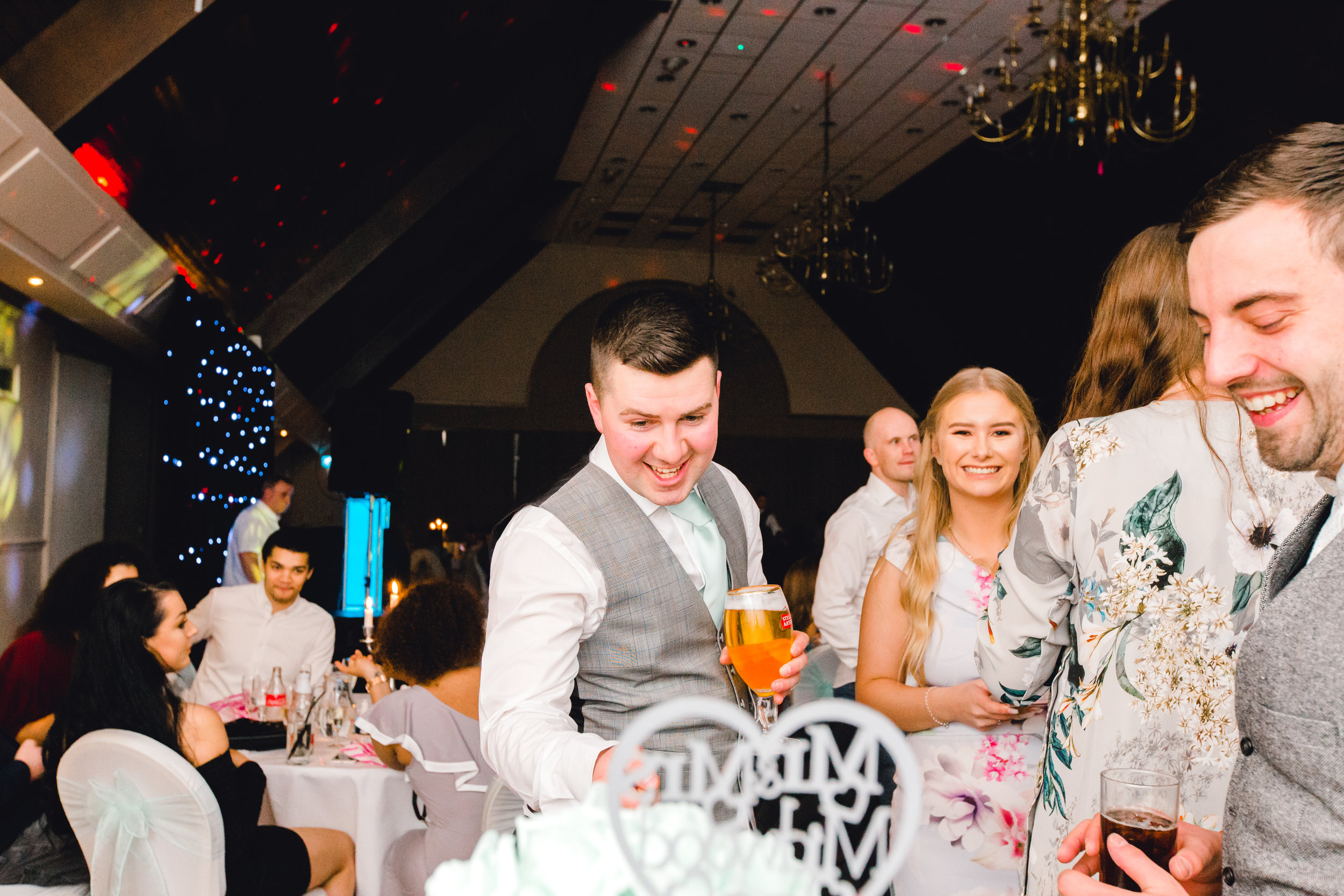 Cheeky best man pretending to cut the wedding cake