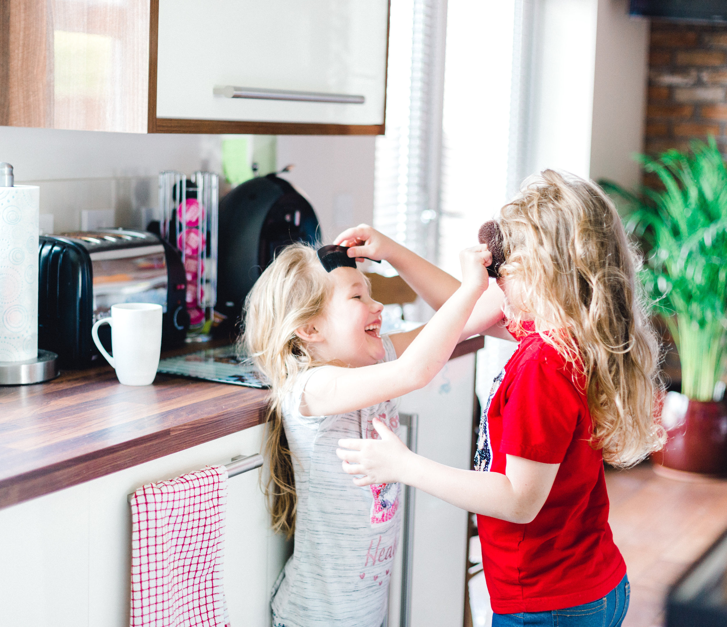 Two sisters joking around during bridal prep at mold wedding