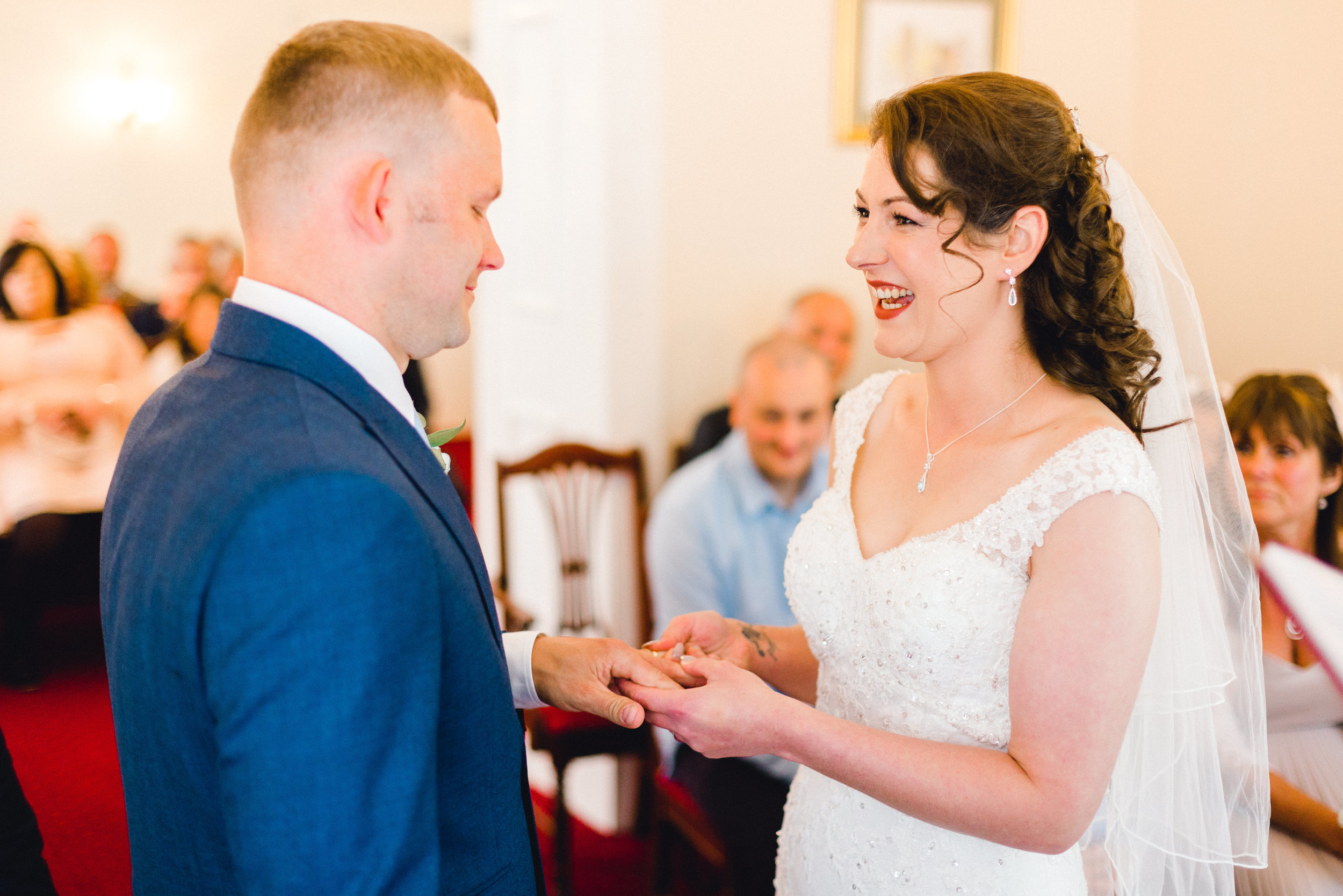 exchanging of rings during wedding ceremony at Llwynegrin Hall