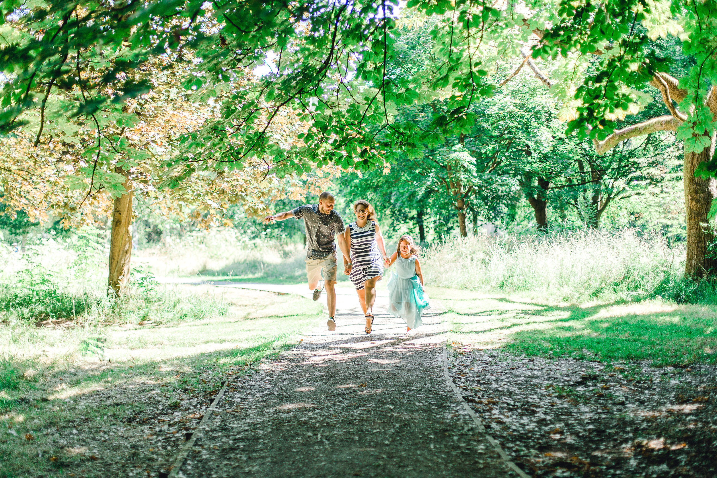 Family doing a fun, hop and skip jump at Fletcher Moss Botanical Gardens