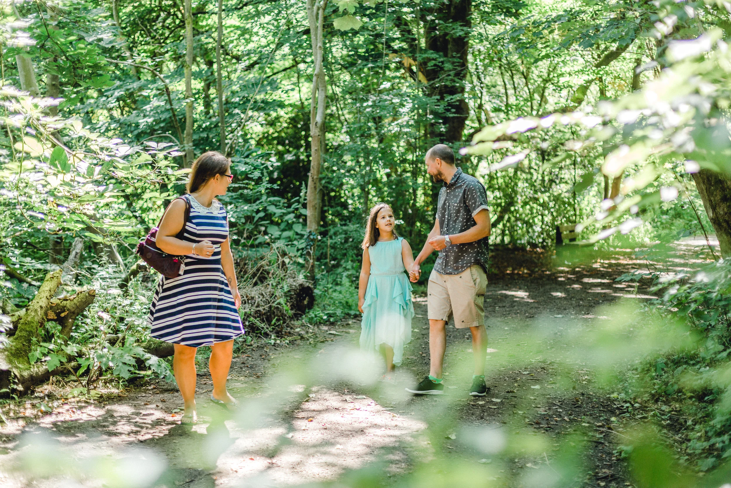 Family enjoying a moment together during pre wedding shoot at Fletcher Moss Botanical Gardens