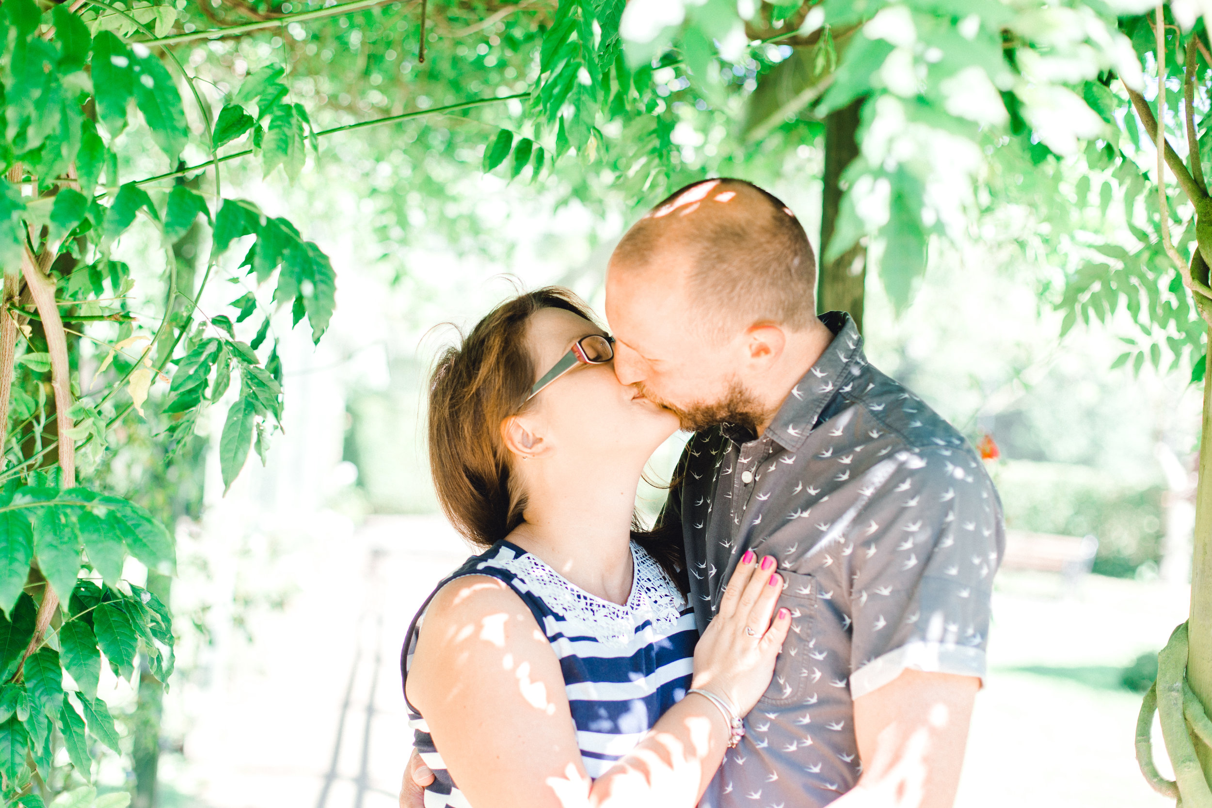 Couple kissing during engagement shoot at Fletcher Moss Botanical Gardens