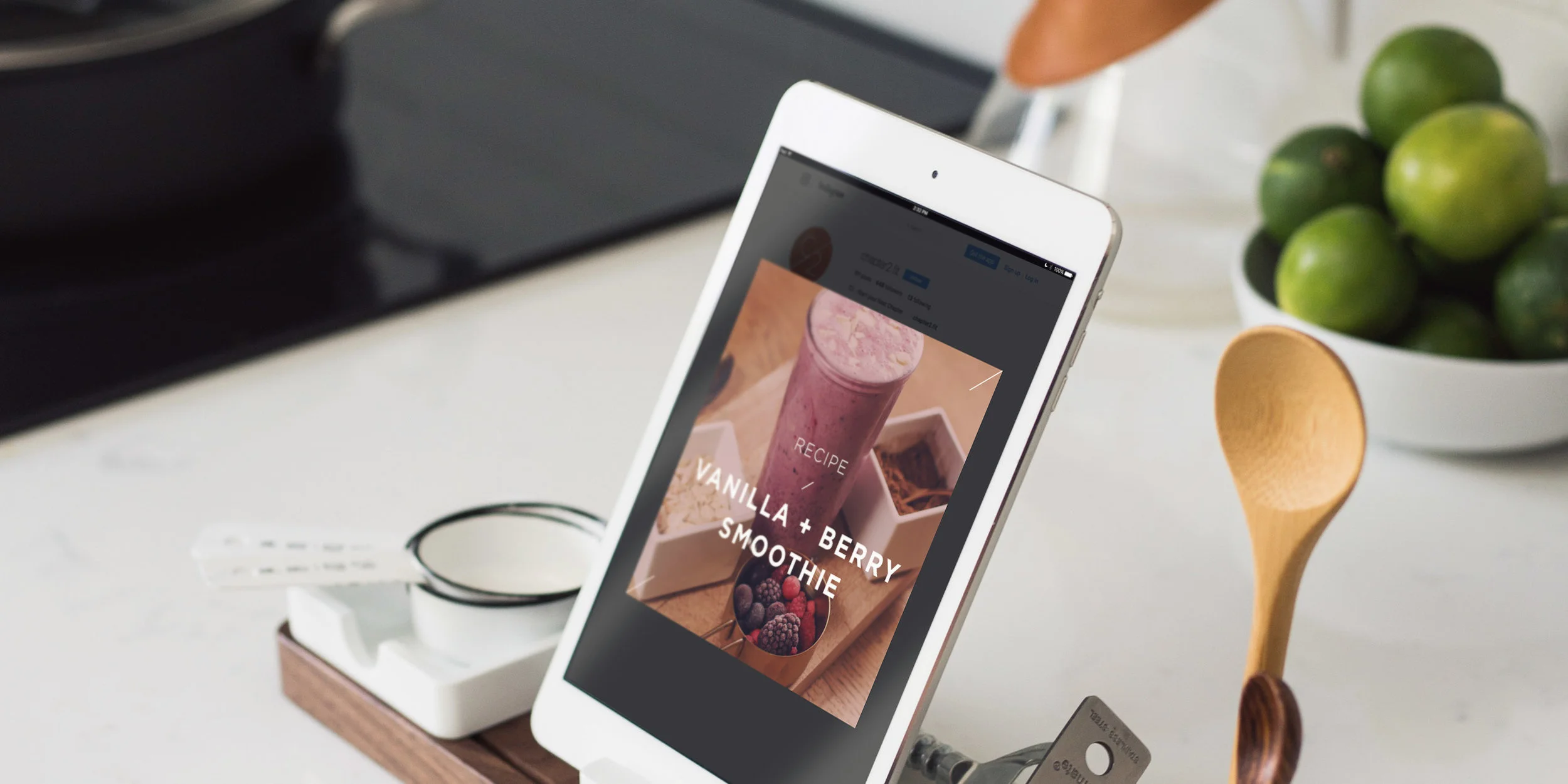 Healthy vanilla and berry smoothie recipe on ipad screen on kitchen counter