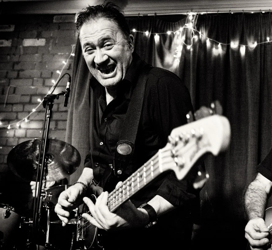 TIM MAWDITT - Bass guitar, vocals Influenced by the post punk R’n’B of Dr Feelgood & 9 Below Zero, Tim spent the majority of the late 70’s & 80’s gigging with bands in the style of his heroes. Later he formed Fatman Swings with Chris Bennett. This kept them busy for 25 years. During this period, Tim played Madness epics with Chris Baker in Nuttyness and Americana music in Slapface & the Hoagies with Chris Bennett. Tim has come full circle again, playing his love of R’n’B. Tim has performed in gigs & festivals across the UK, Europe & America.