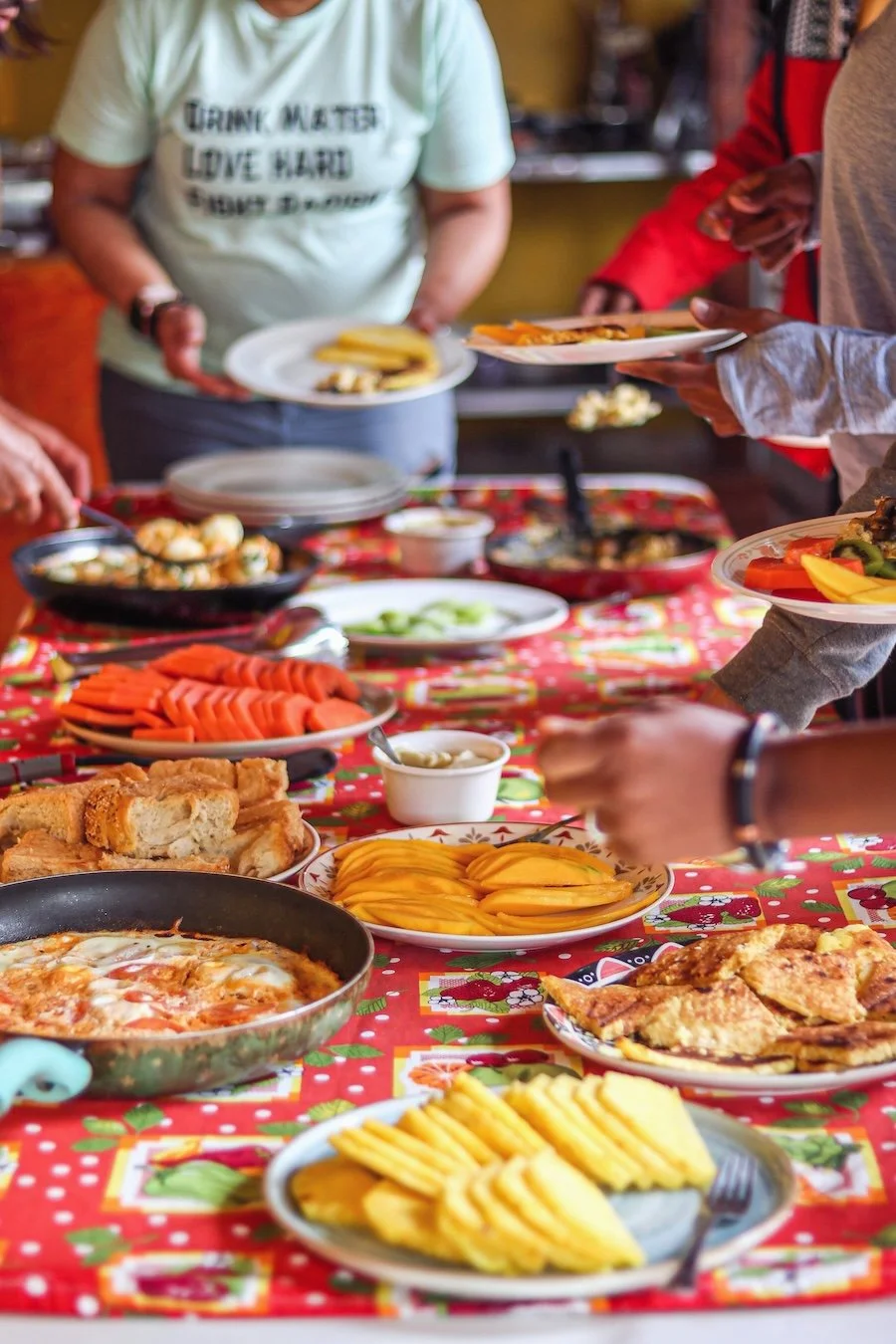 Shared meal with fresh fruit and local dishes during a Leisano Living experience