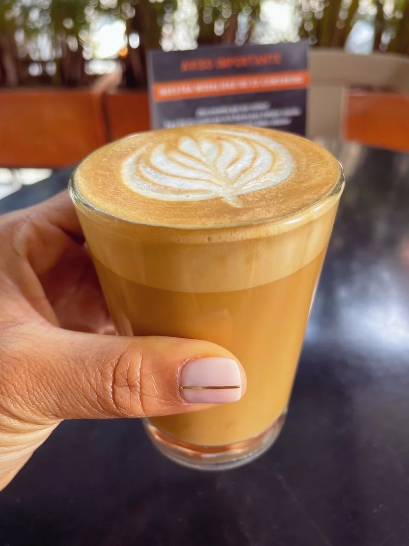 Close-up of coffee in hand at a café in Medellín, Colombia