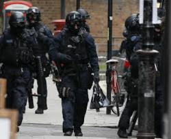 Specialist tactical officers moving through Victoria Village