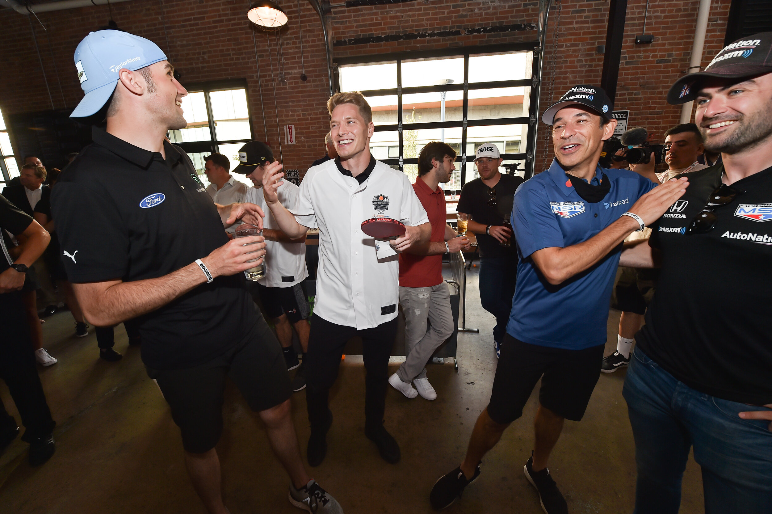 Drivers share a laugh at Josef Newgarden's Celebrity Ping-Pong Challenge.