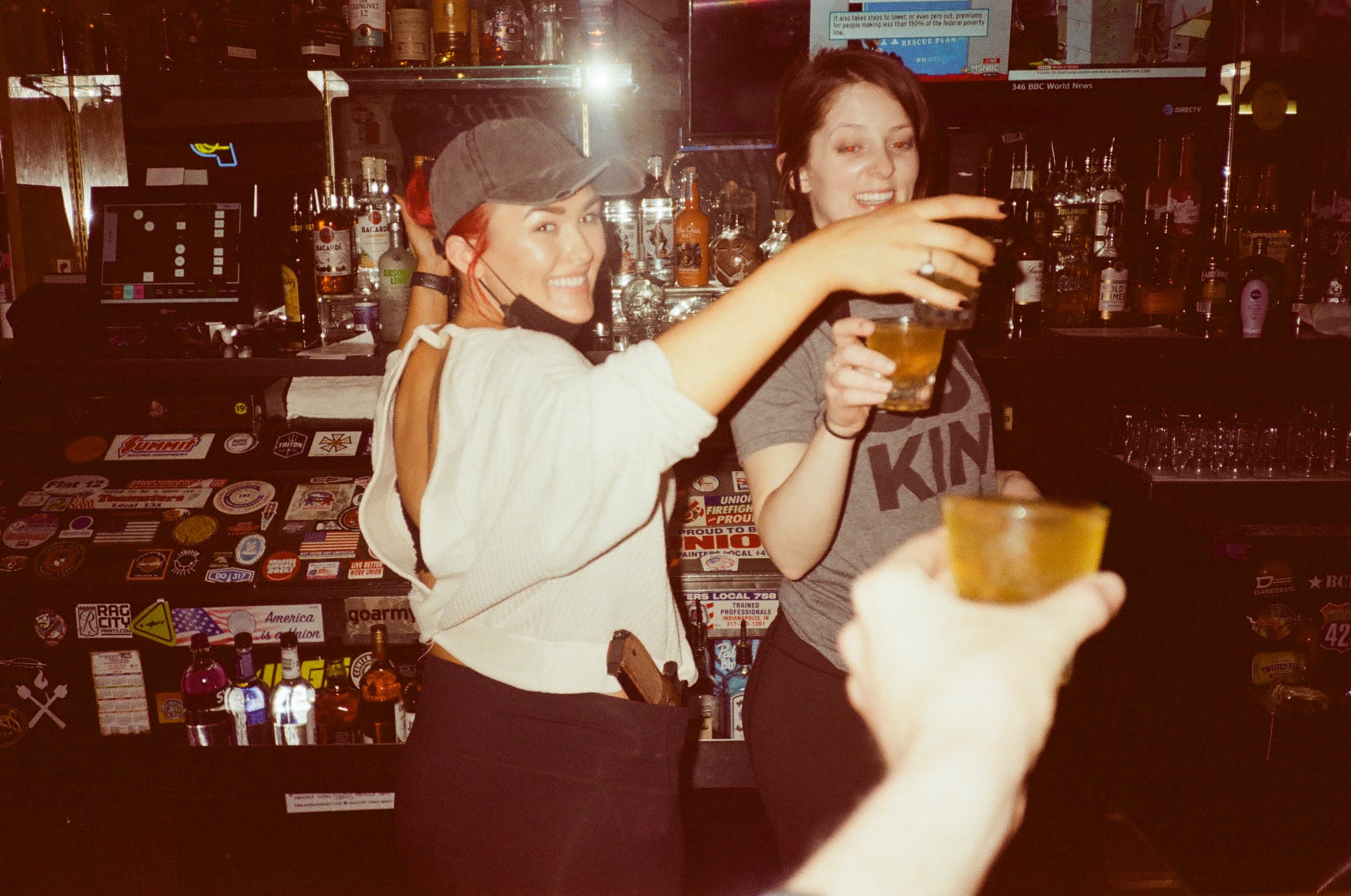  Megan and Brooke are two of the finest bartenders in town. As you can tell from the photo, they take no shit!  Camera: Fuji Discovery Mini Dual  Film: Kodak Gold 200 (expired) 