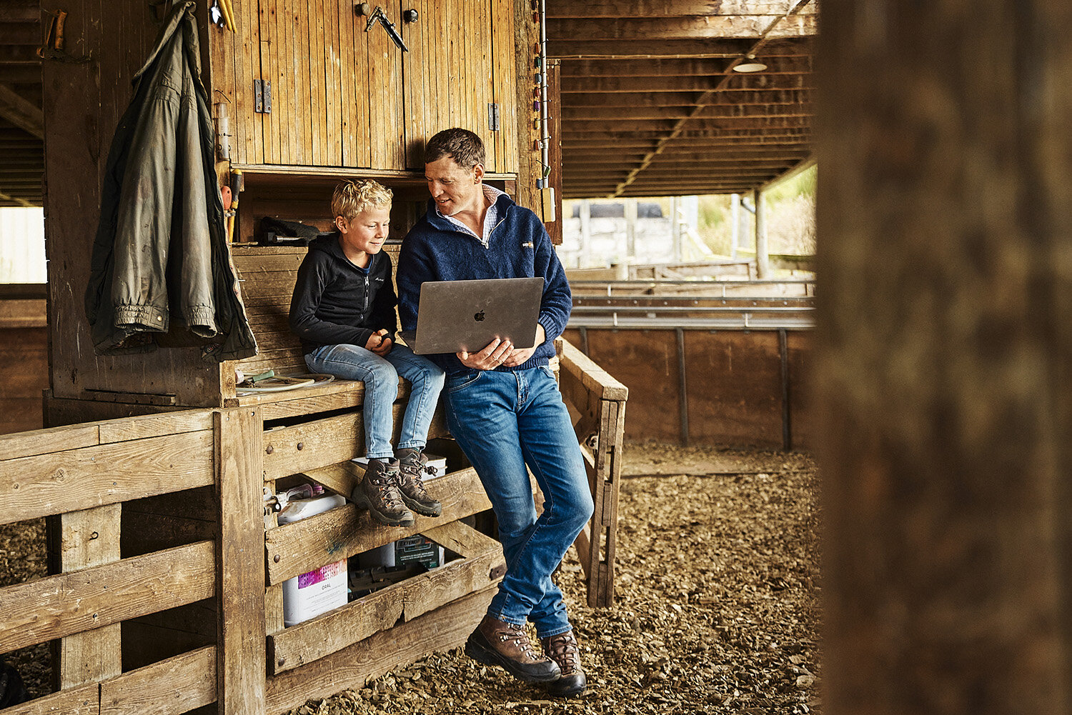 IVDM Photography_South Island farmer is sheep shed on technology with son.jpg