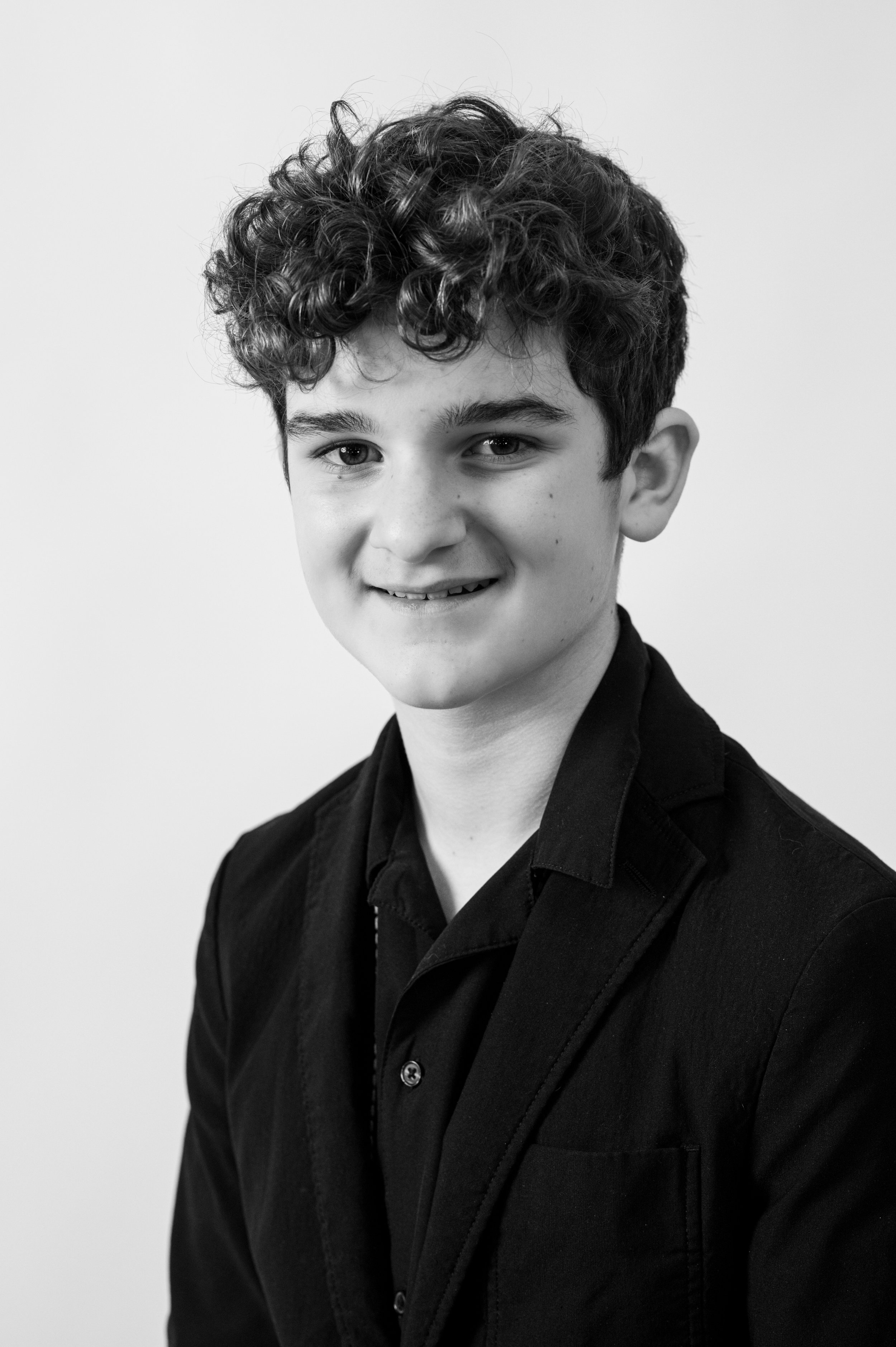 Young Man in black suit smiling