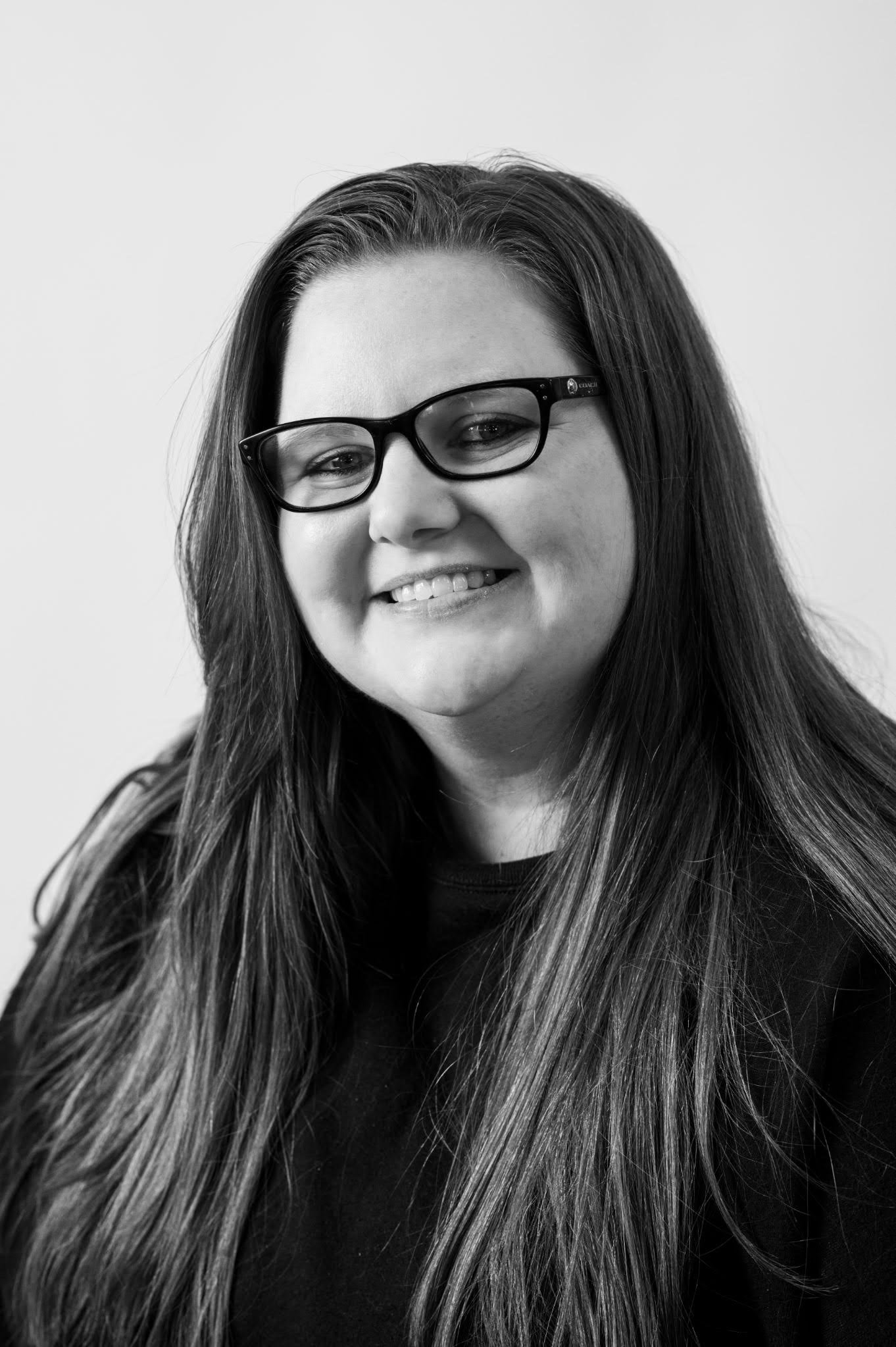 Kayla Headshot Posed with a Smile and glasses