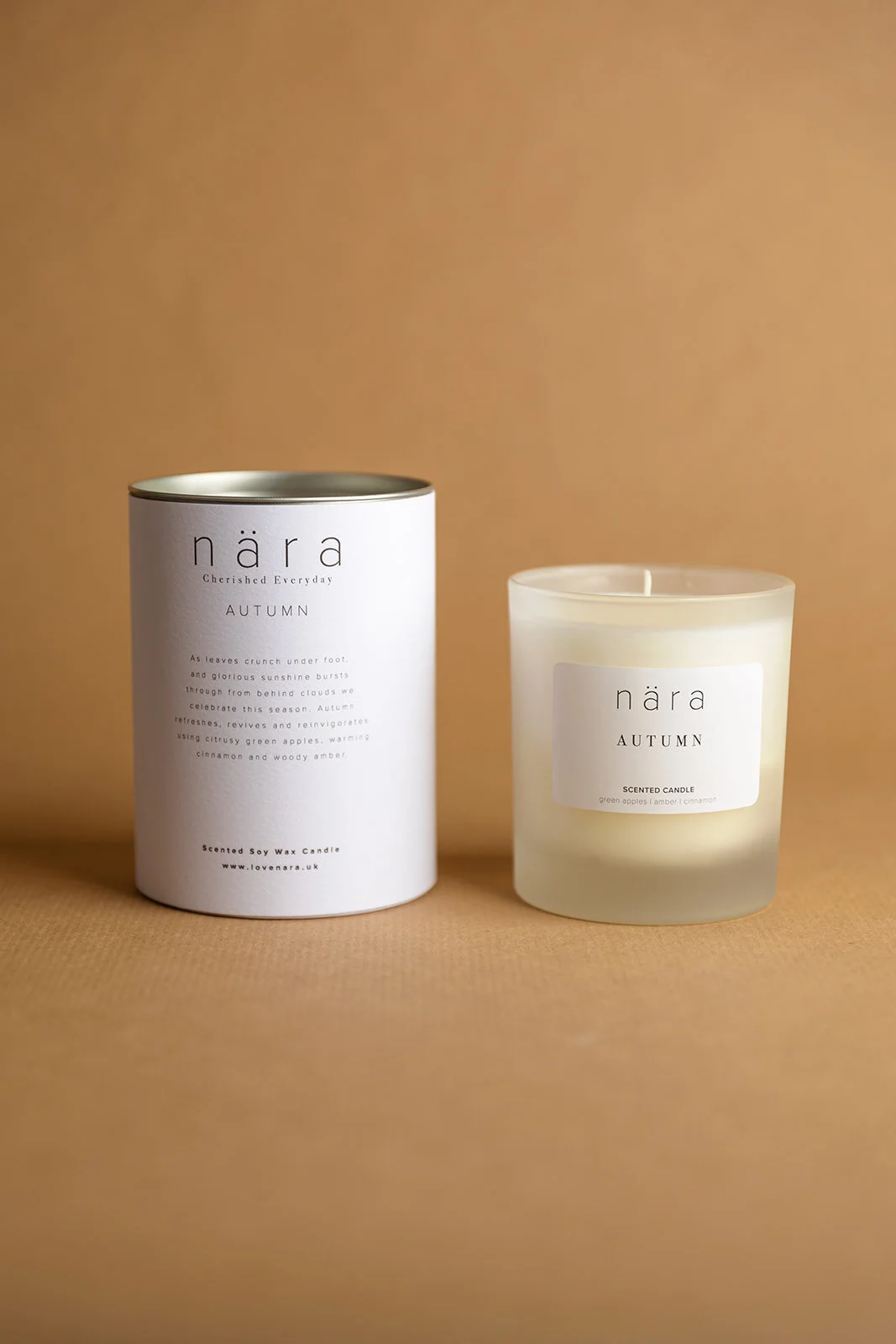 Autumn Candle 300g in frosted glass alongside packaging set against a warm background