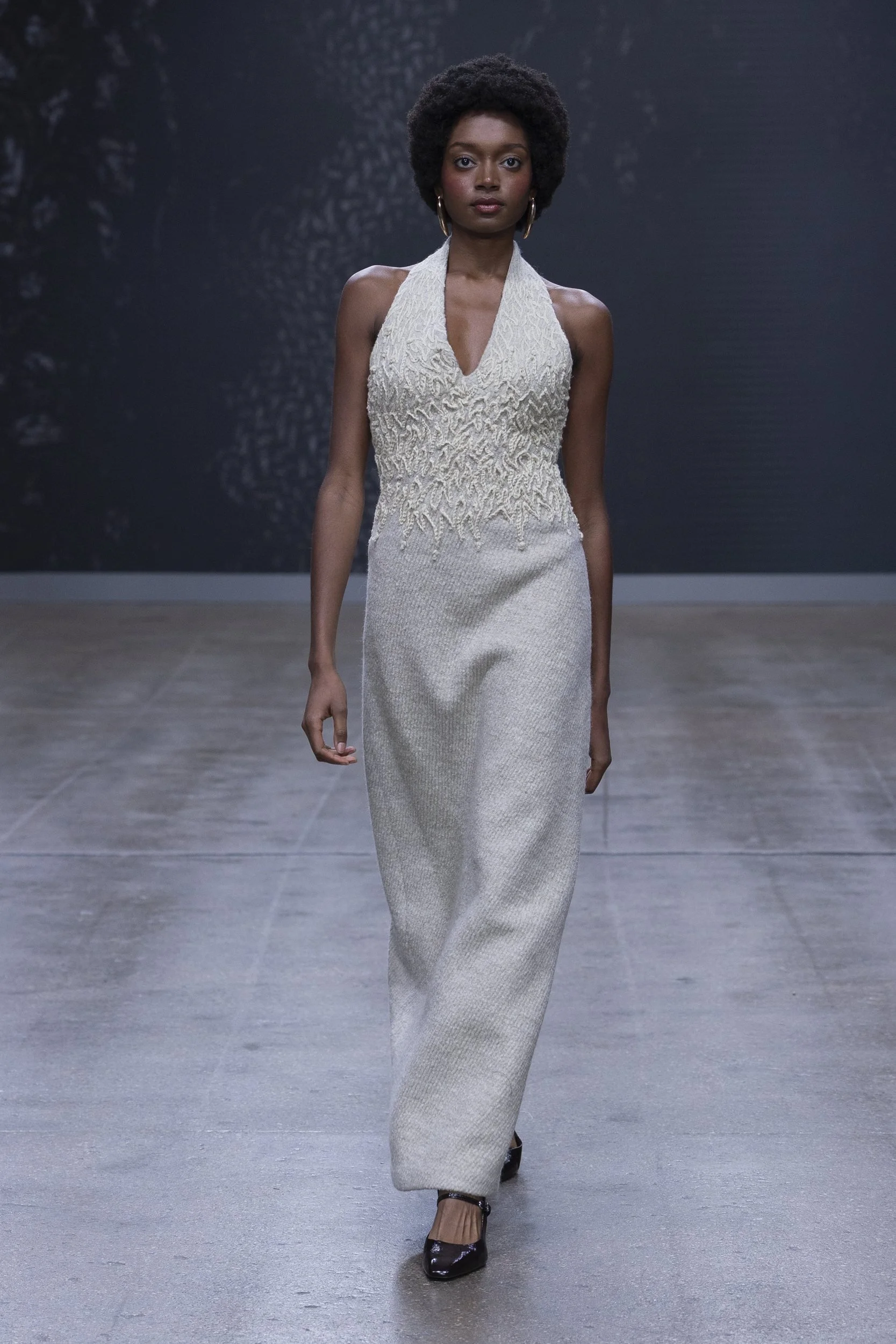 Model in a white textured halter gown from ALISADUDAJ Silent Engravings at London Fashion Week SS26.