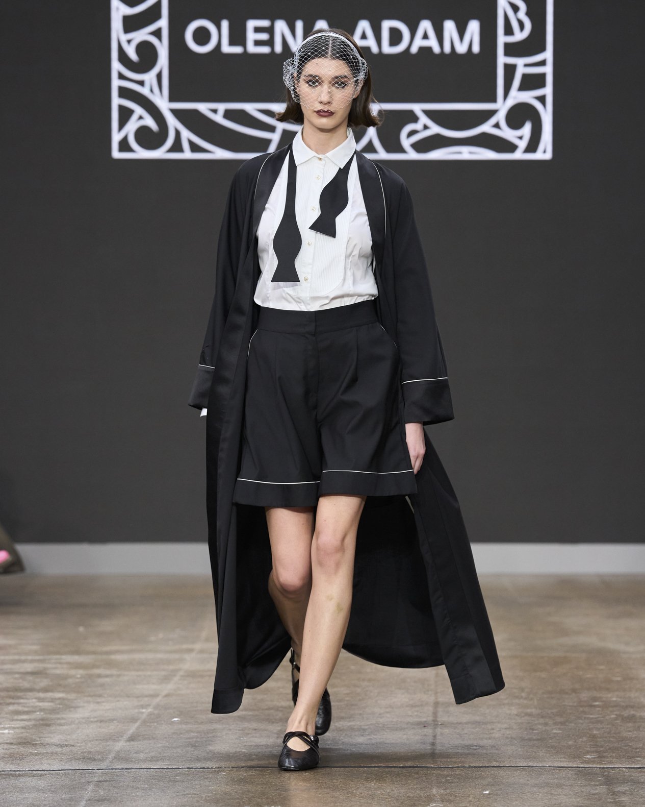 Olena Adam FW26 runway look featuring the Festan silhouette and modern ceremonial womenswear at London Fashion Week